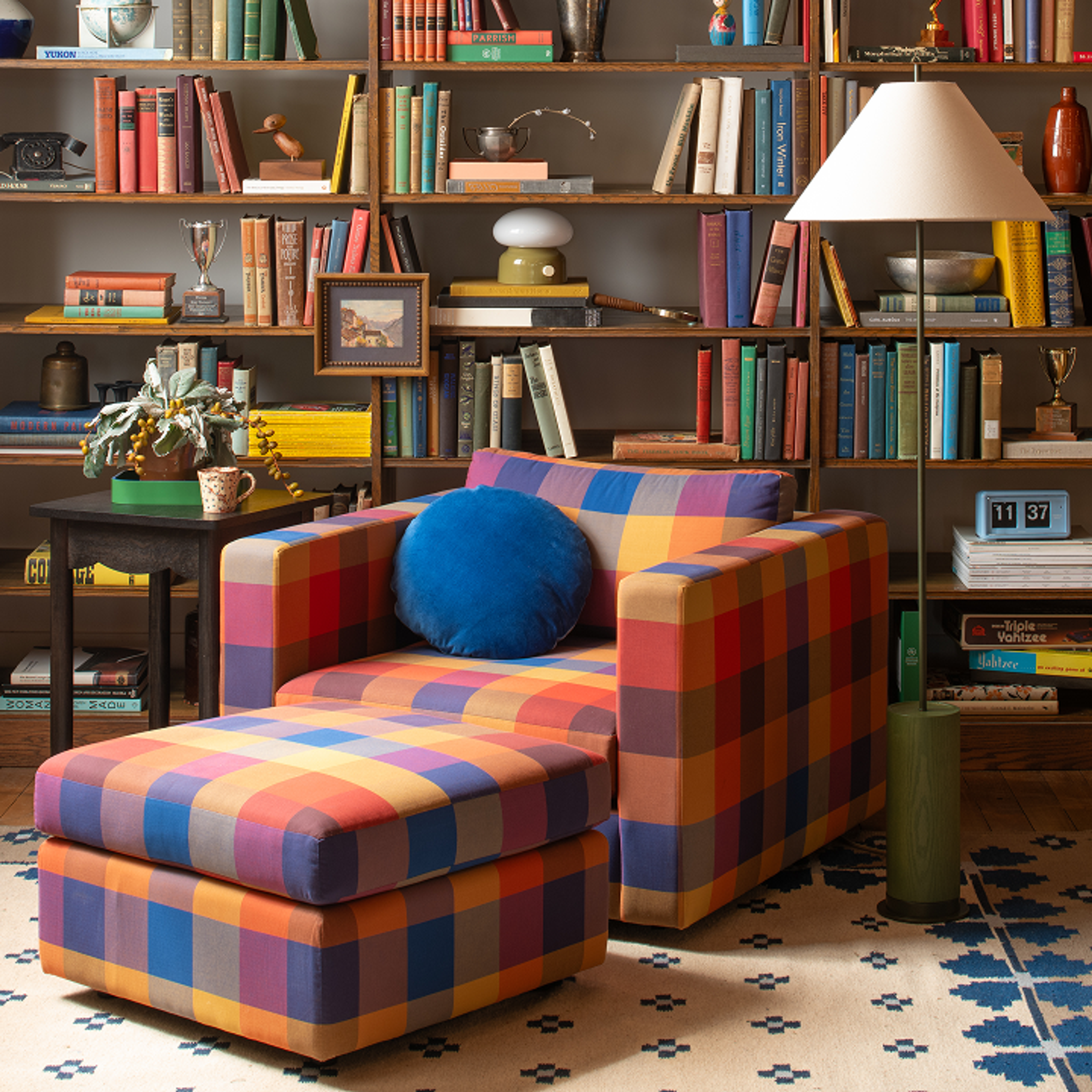 living room scene with couch, coffee table, and book shelf