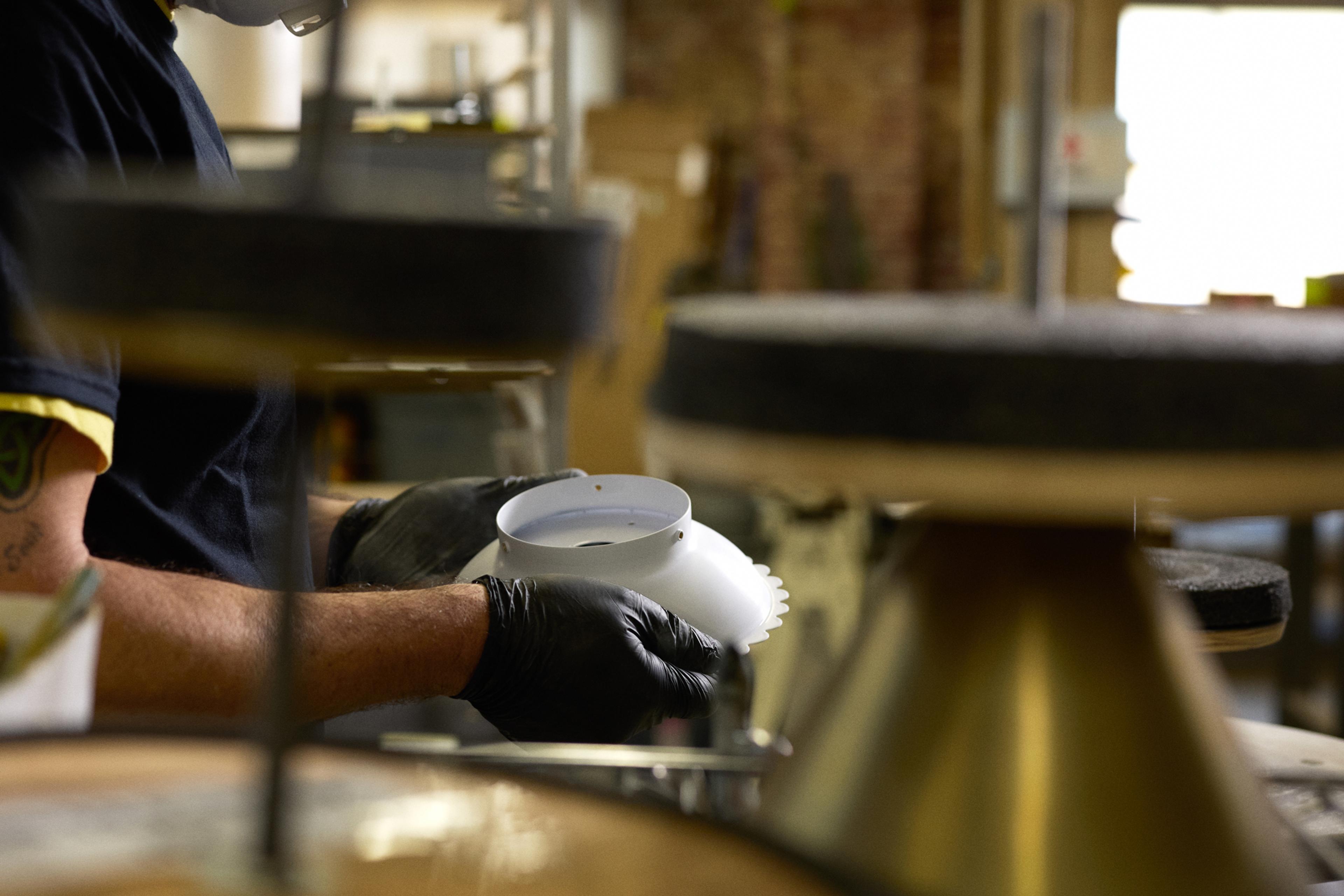 hands sanding light fixture