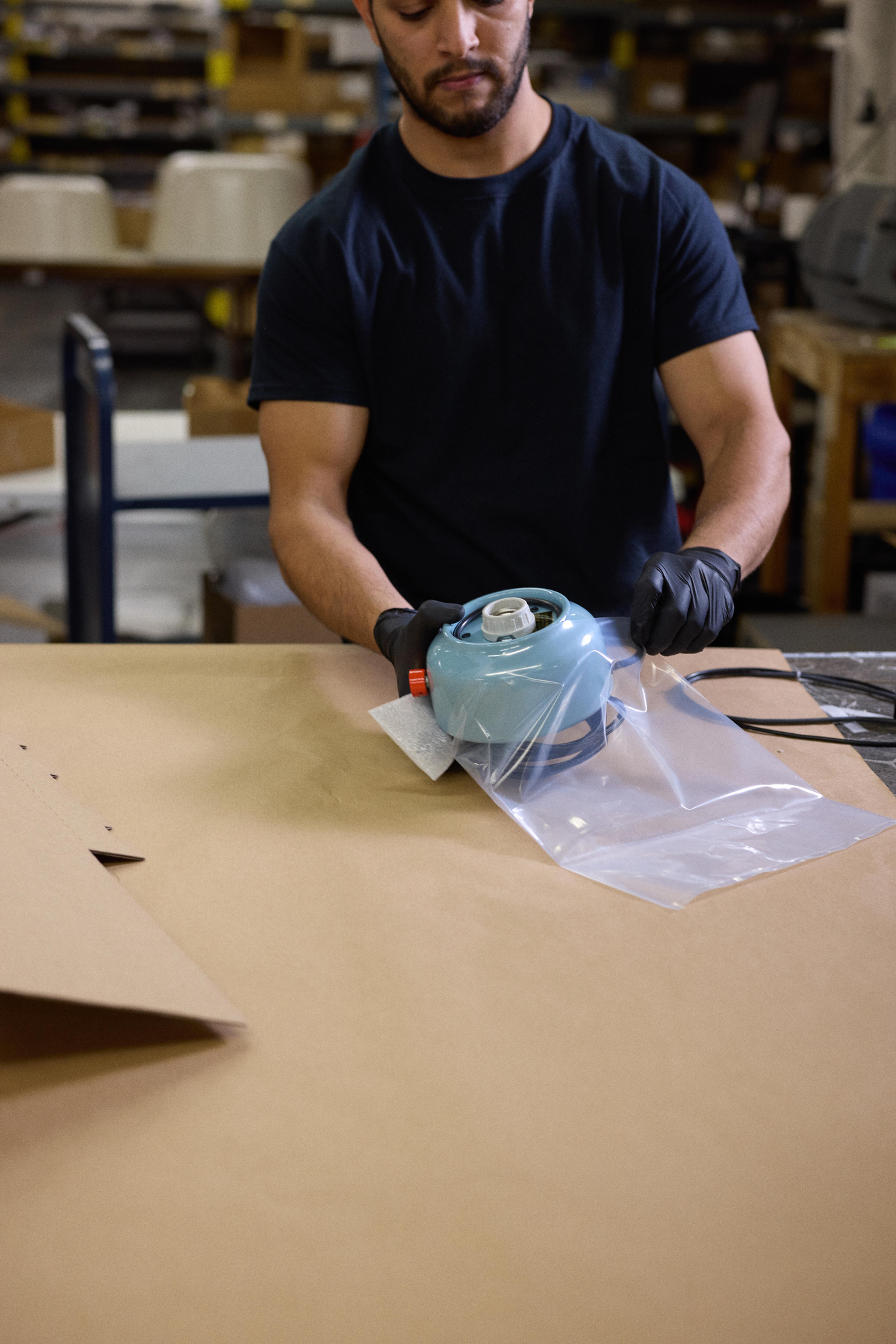 person packaging up a lamp