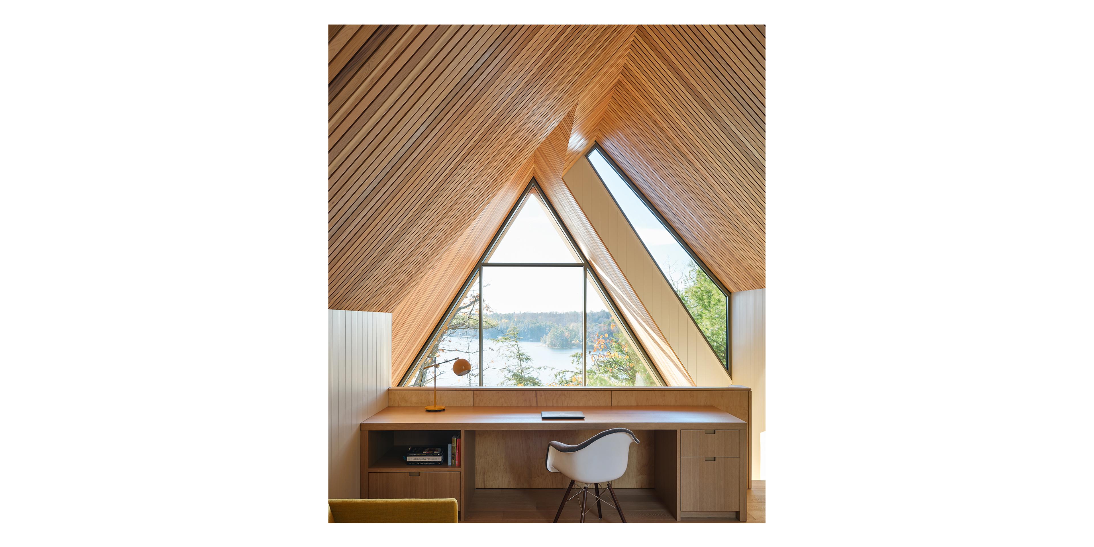 Desk with a large window in front of it.
