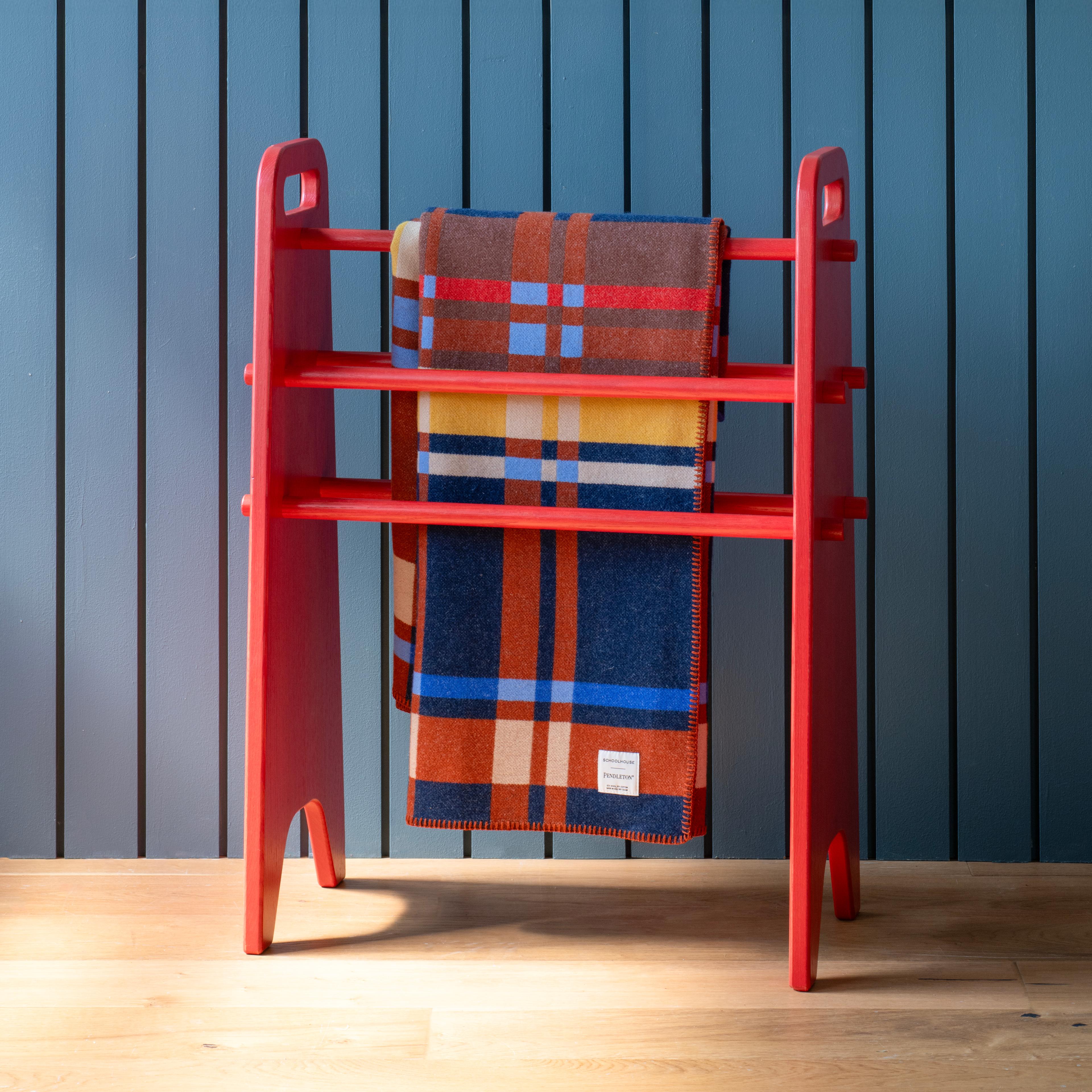 Plaid blanket on a blanket ladder.