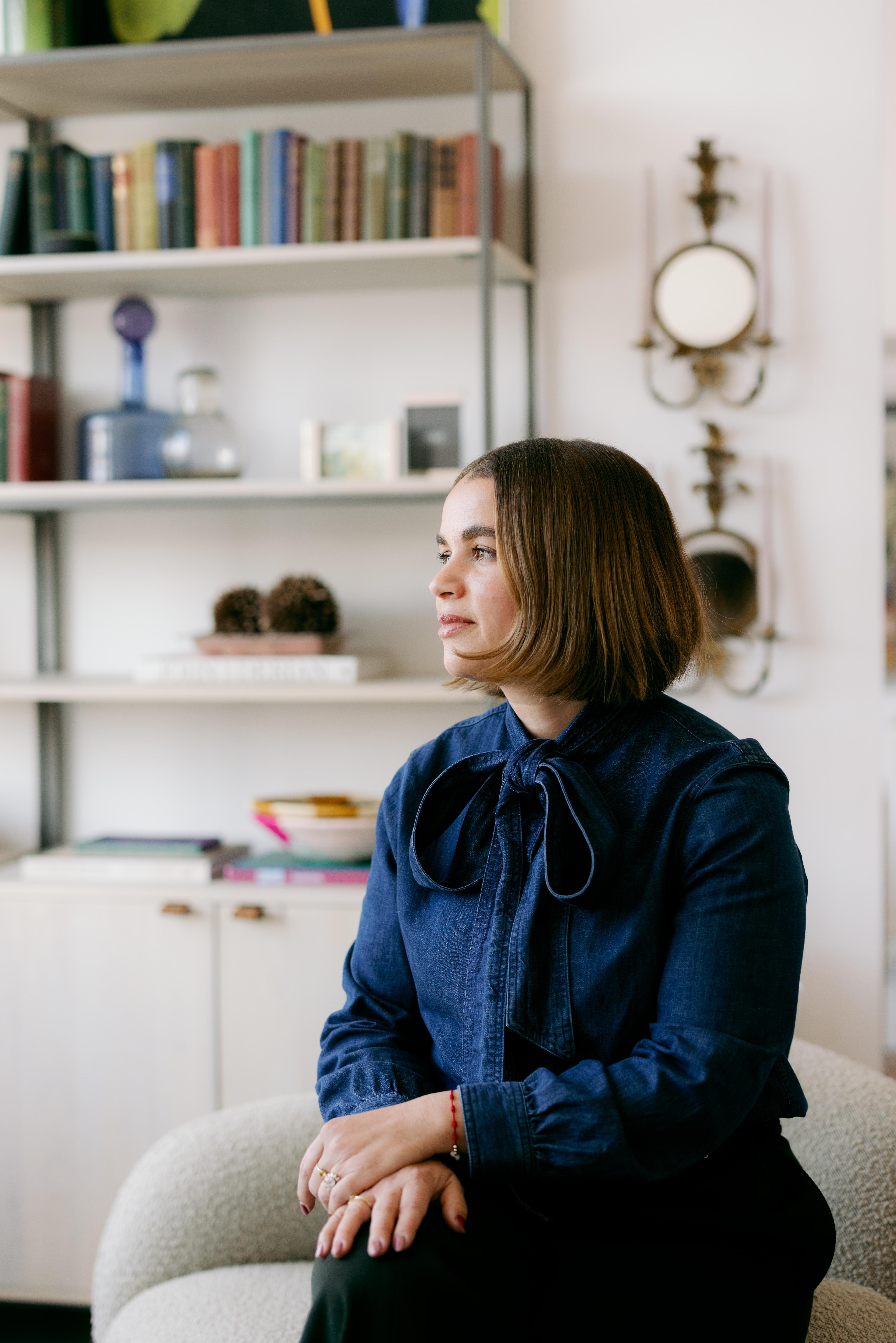 headshot of designer wearing blue 