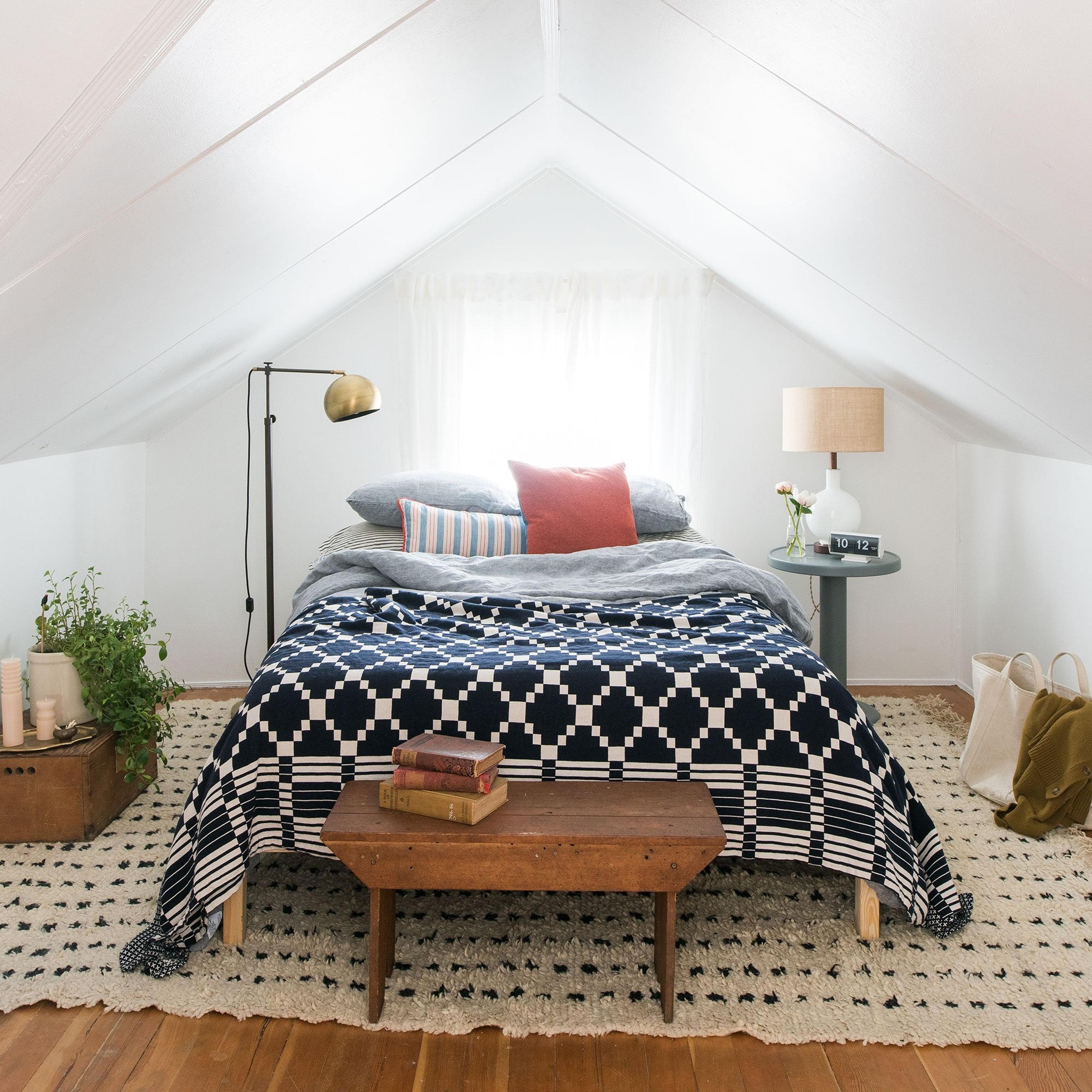 bed with a blue and white bed spread