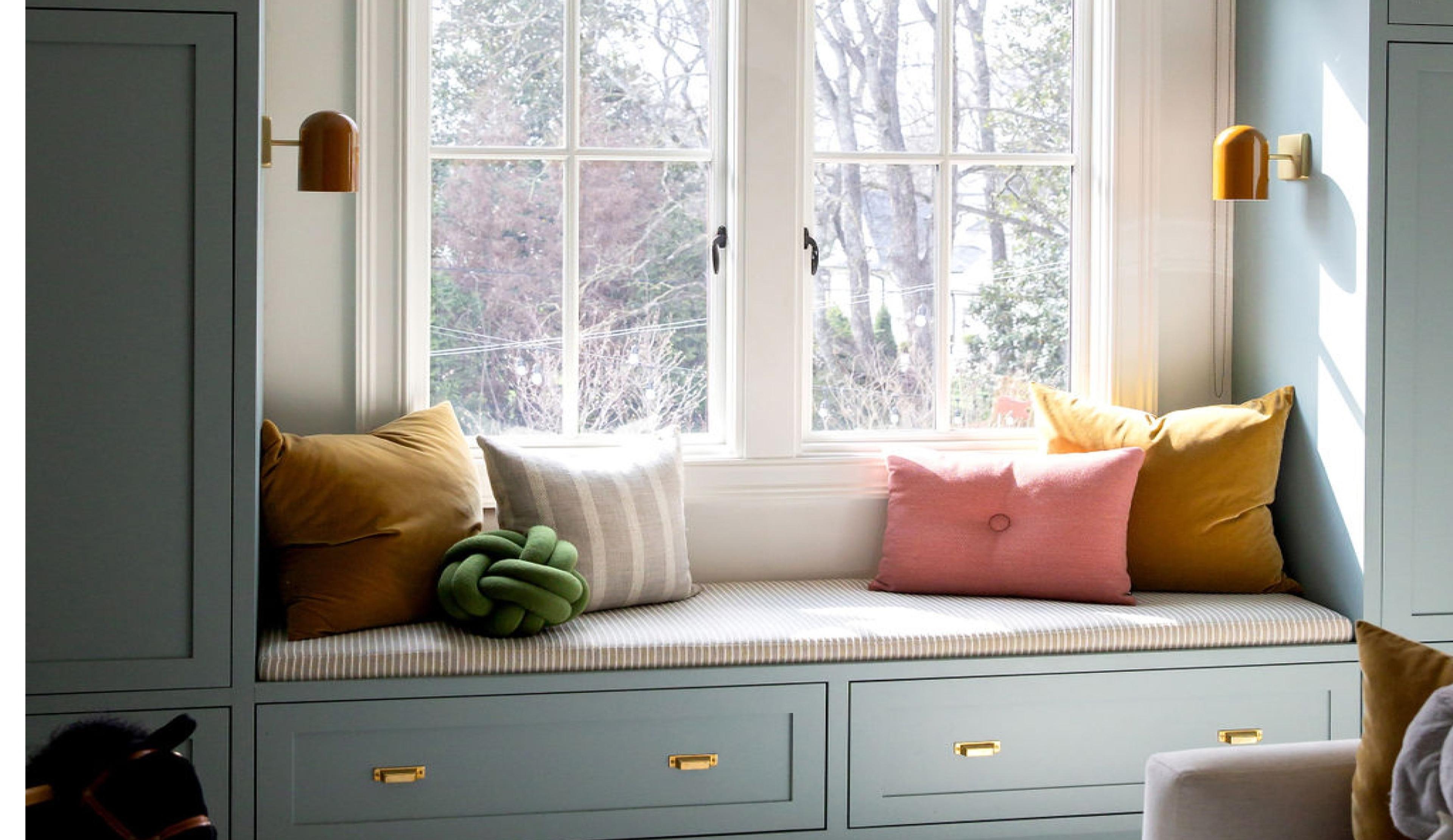 Blue built-ins with pillows on a bench.