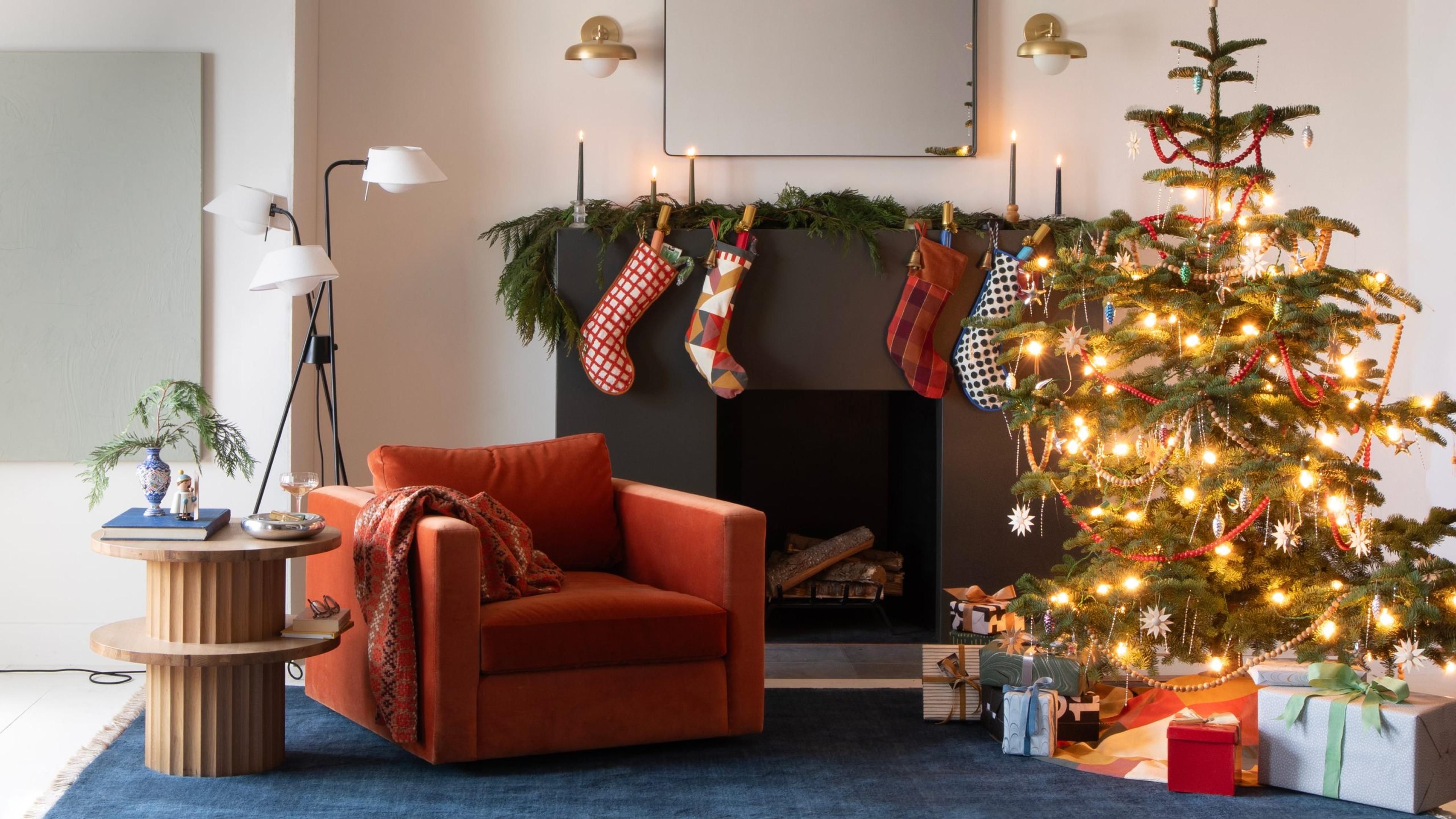 living room decorated for the holiday with tree in front of fireplace