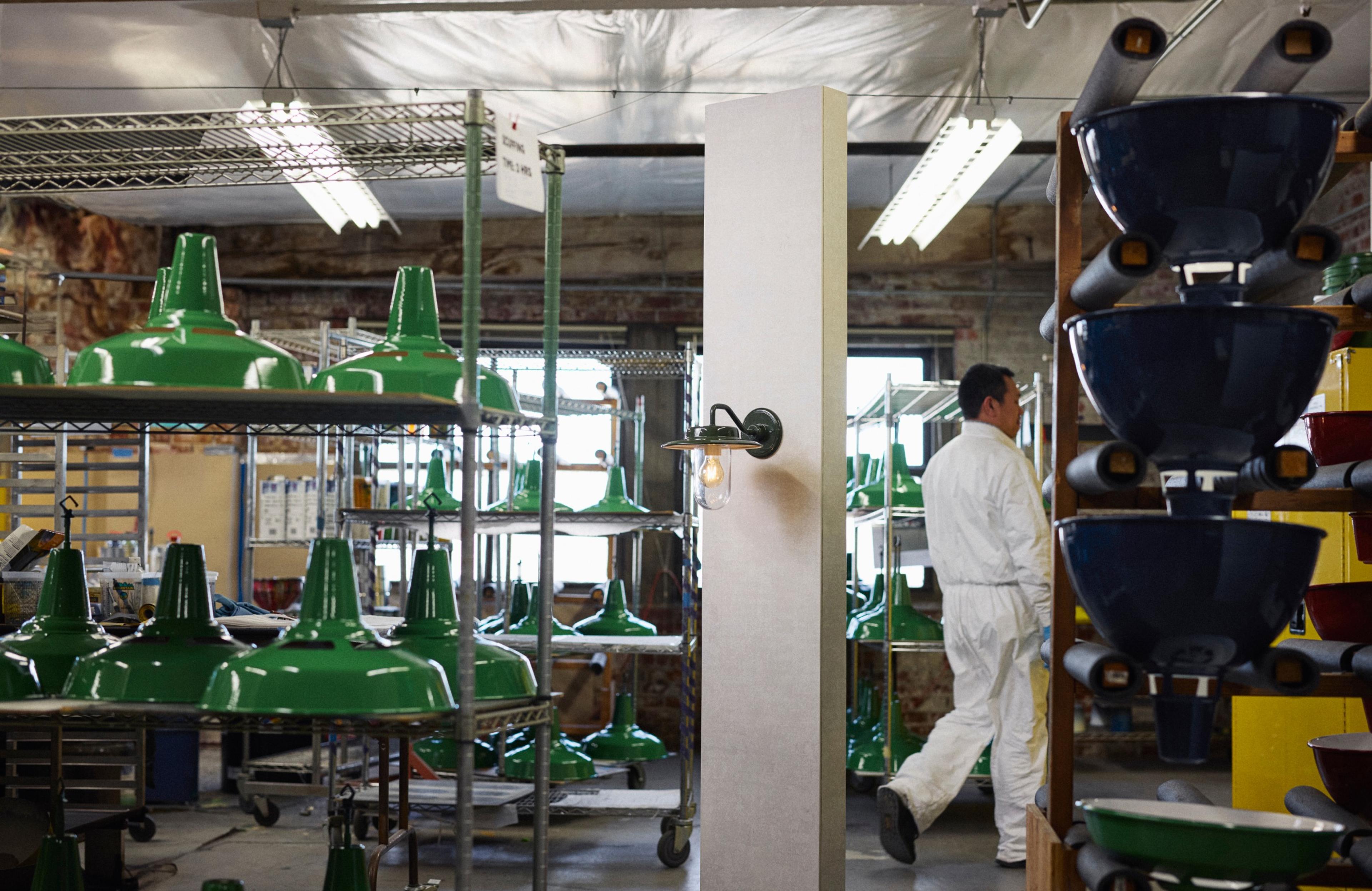 schoolhouse factory lights drying on racks are being painted