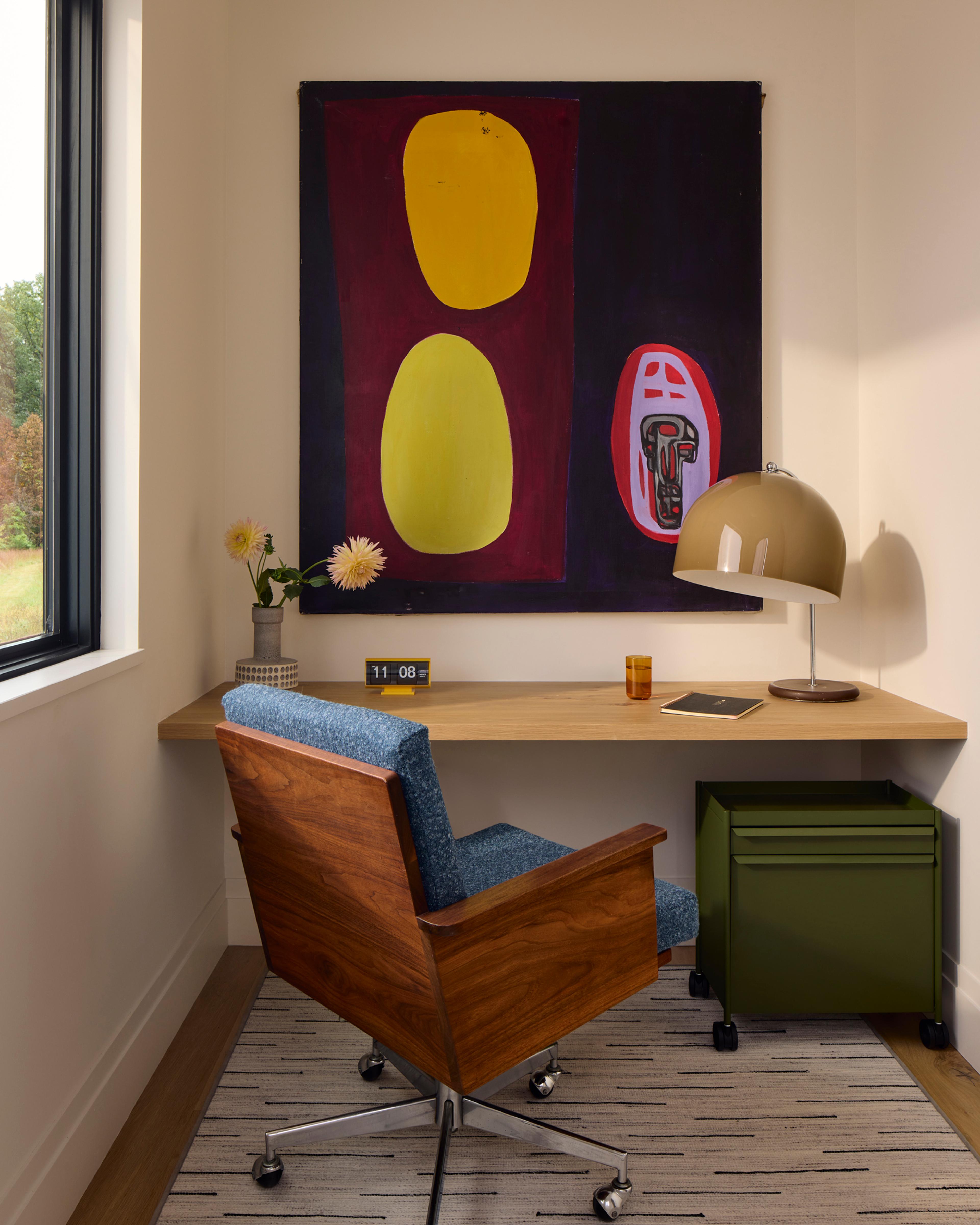 Office with abstract art and table lamp