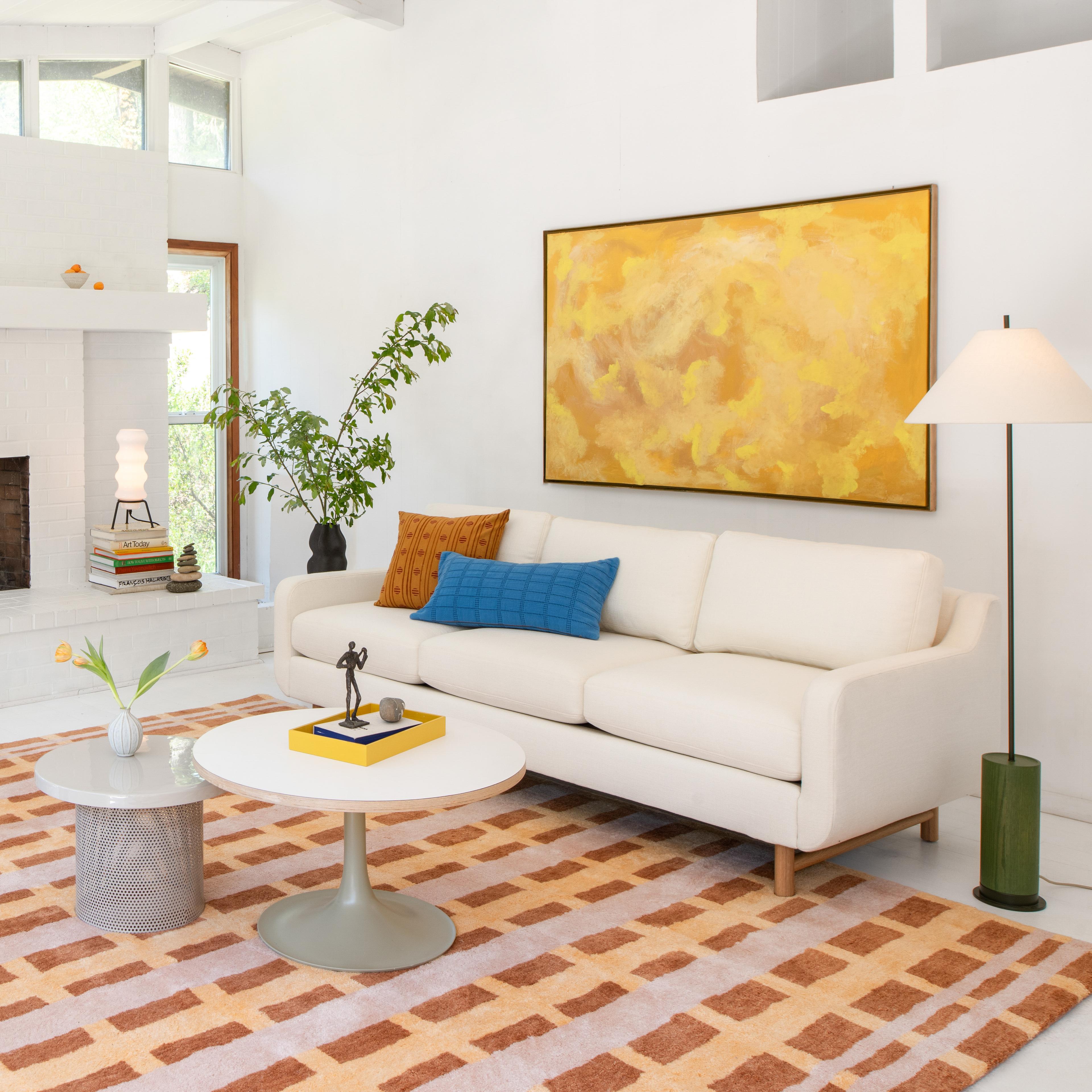 Modern living room with wooden coffee table and colorful throw pillows