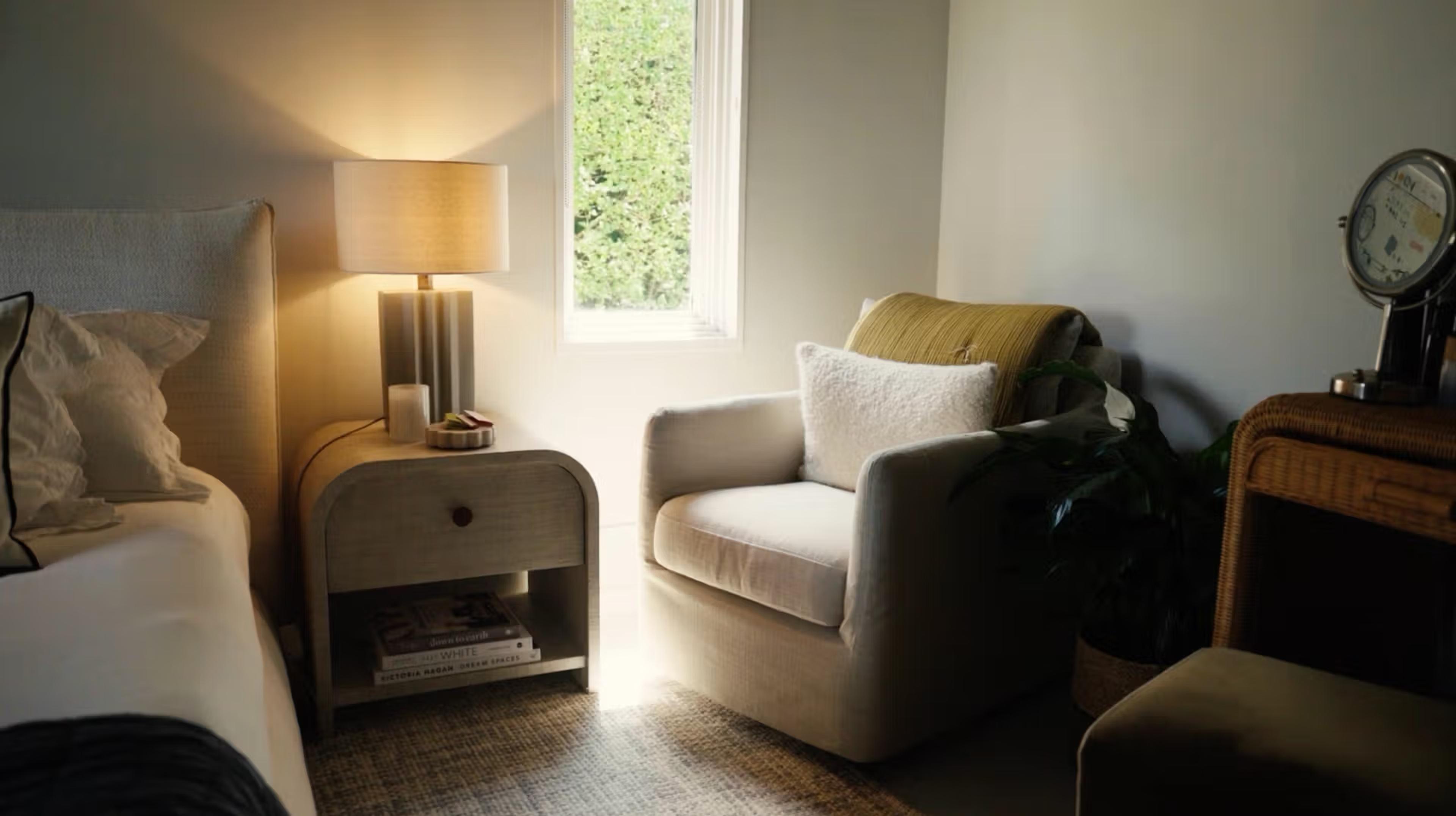 corner chair of primary bedroom next to nightstand