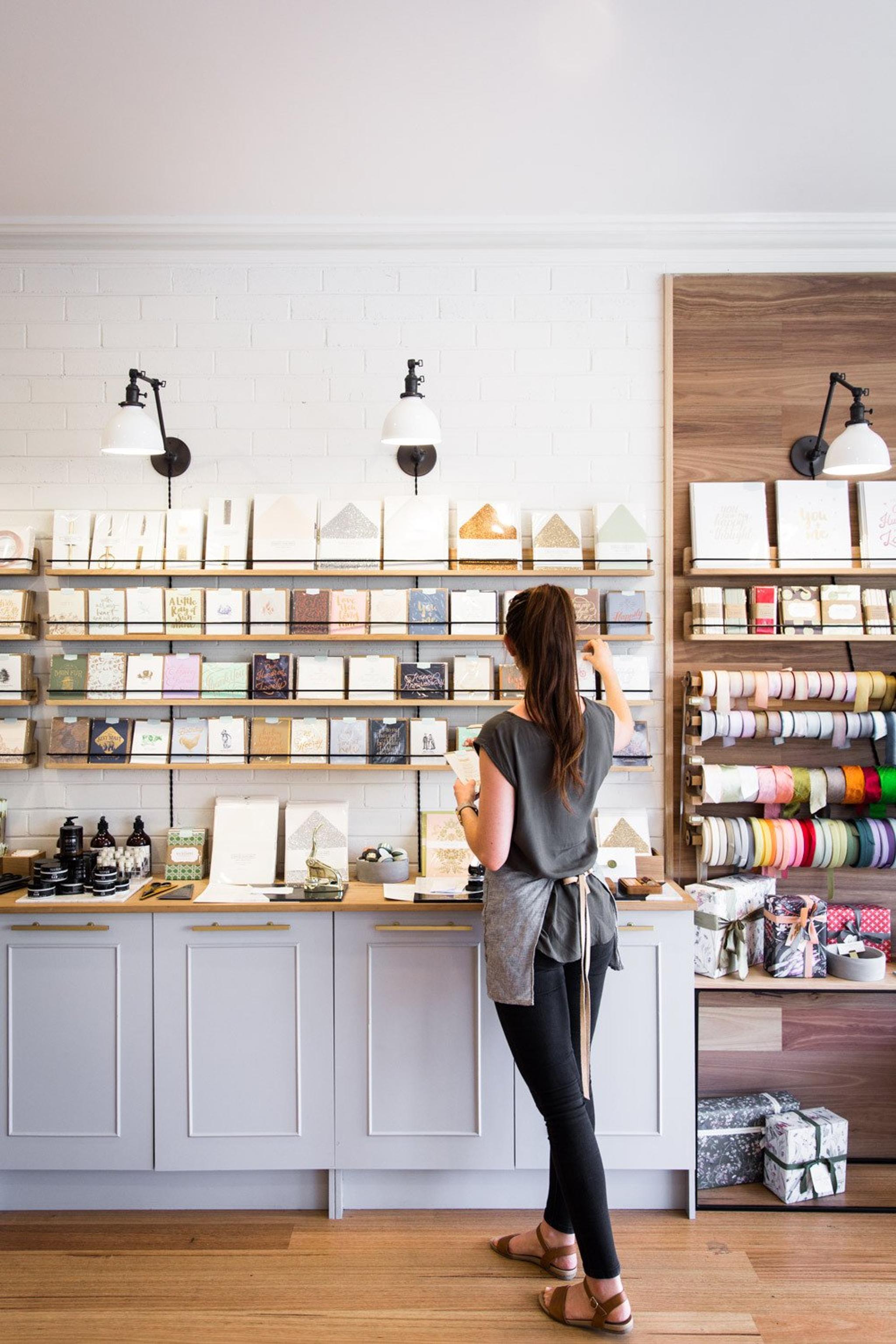 woman standing in front of a counter with many objects on it