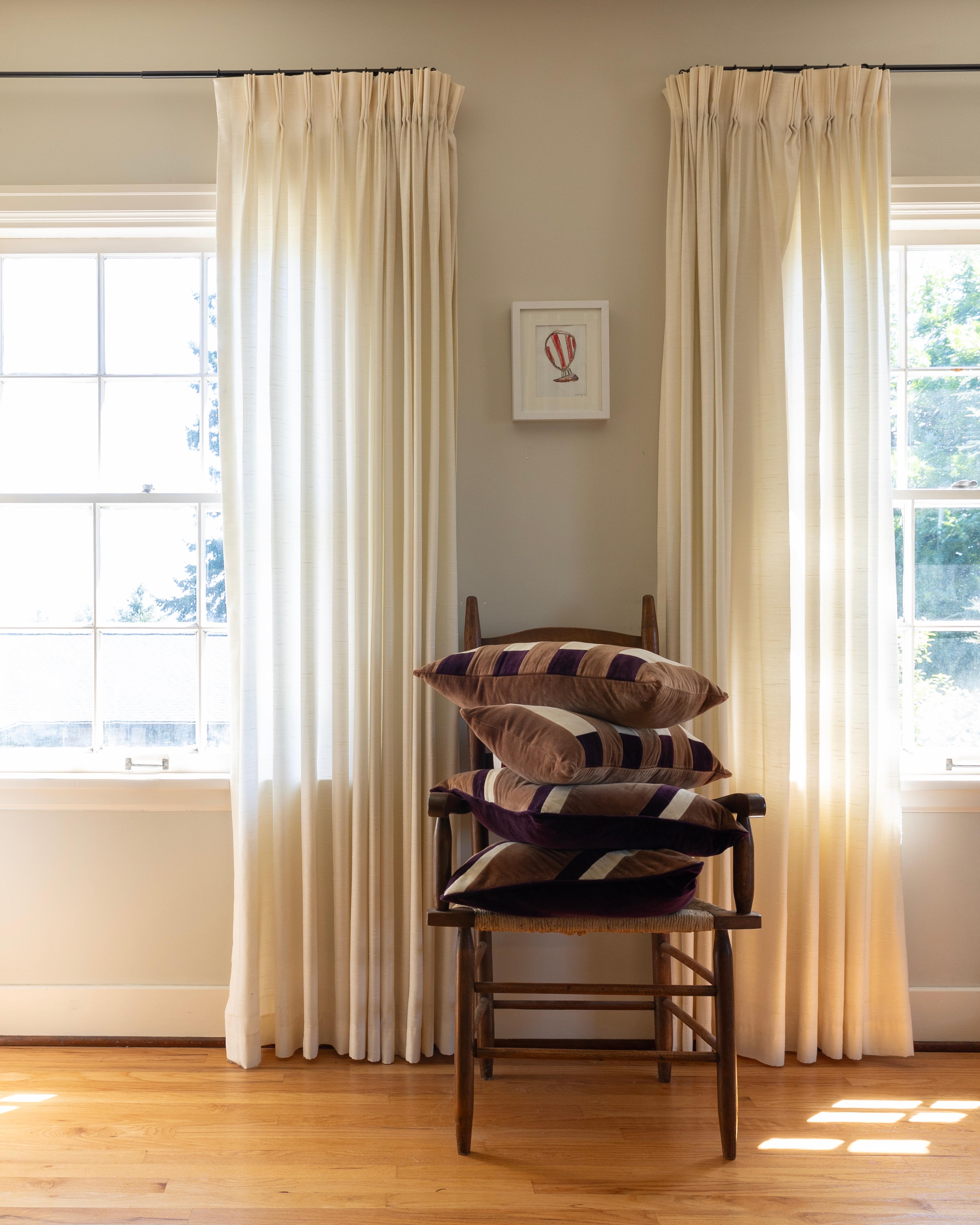 Pillows stacked on a chair.