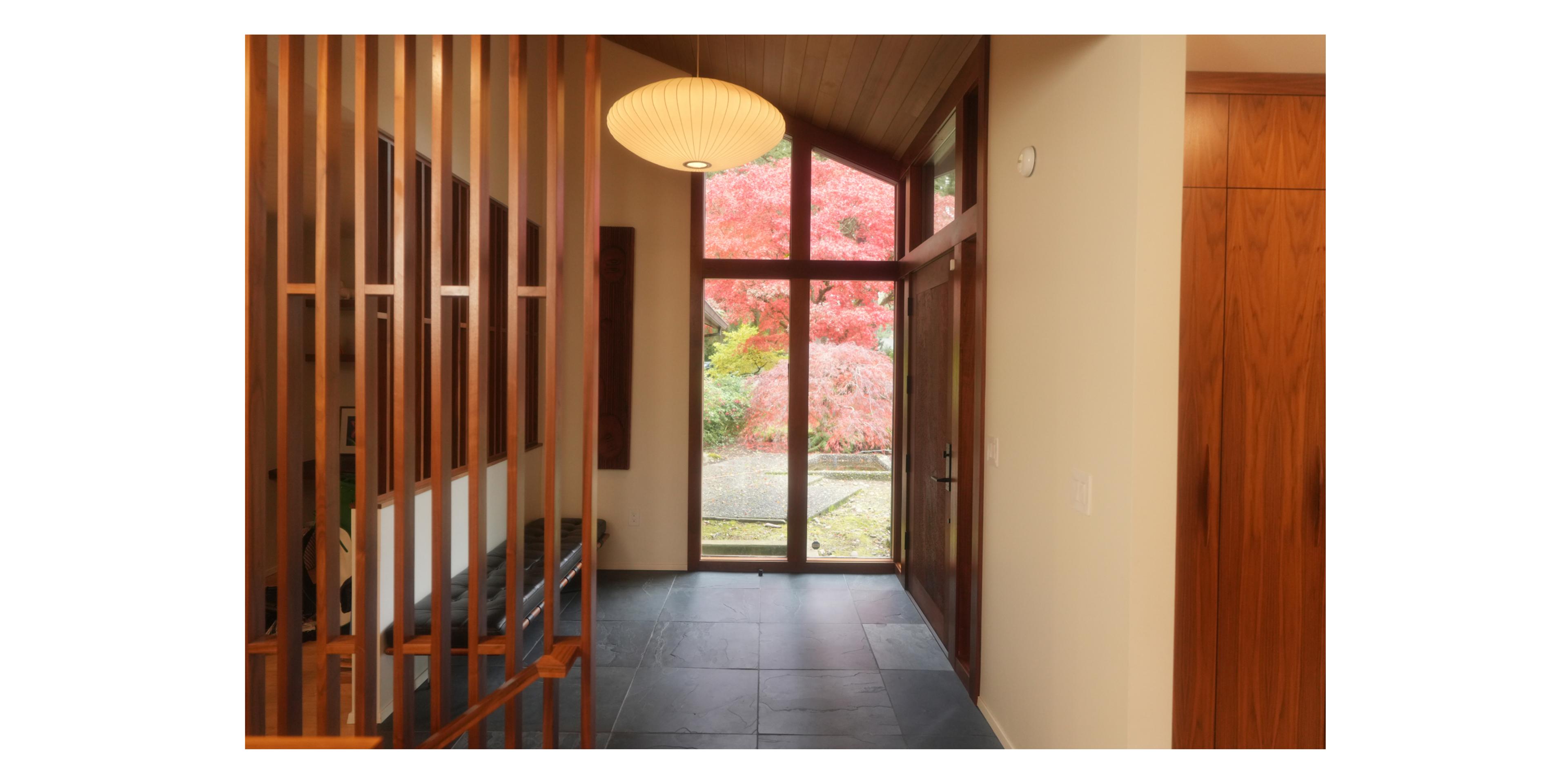 entryway to wood paneled foyer 