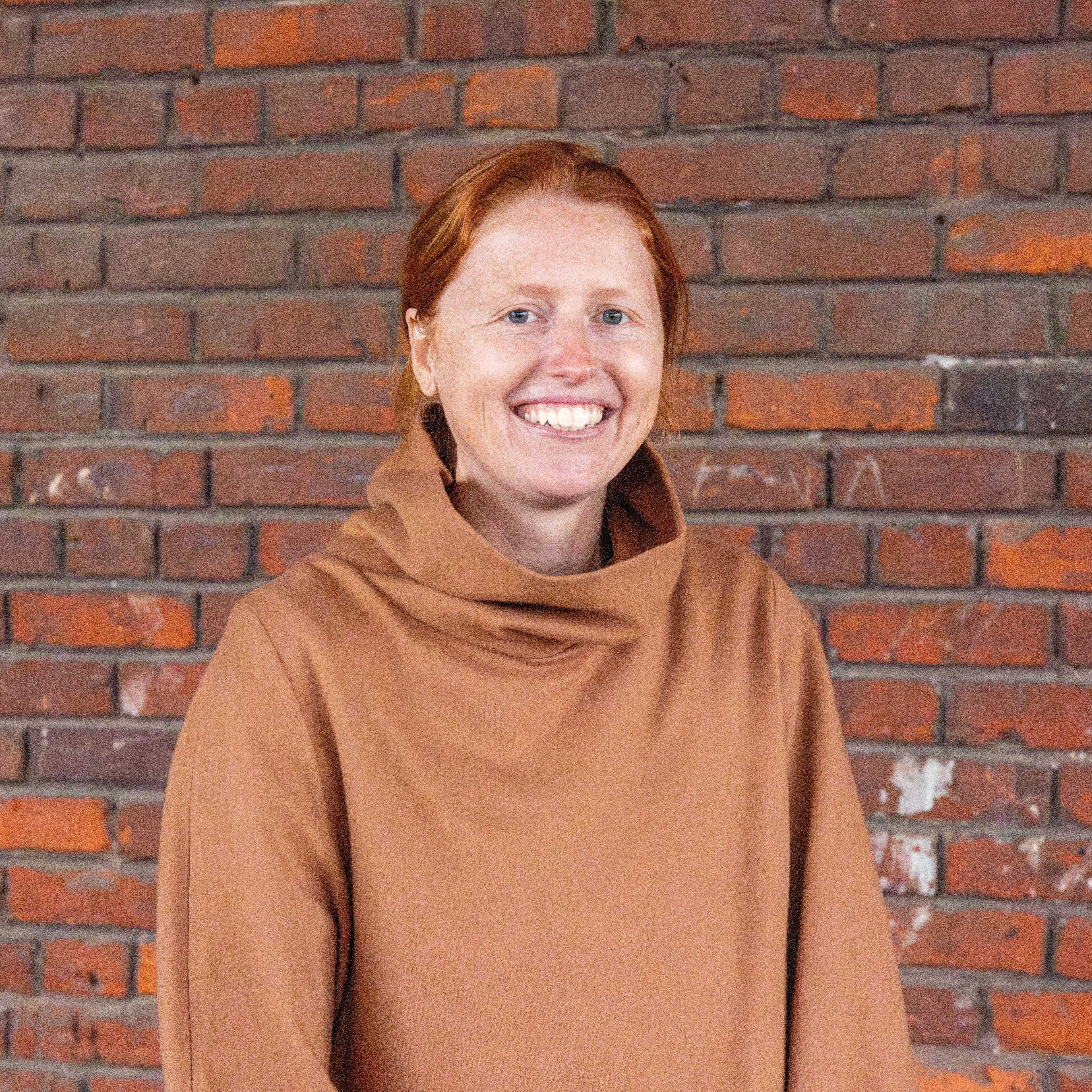 Parrish Duncan, Trade Marketing Specialist Girl in front of brick wall