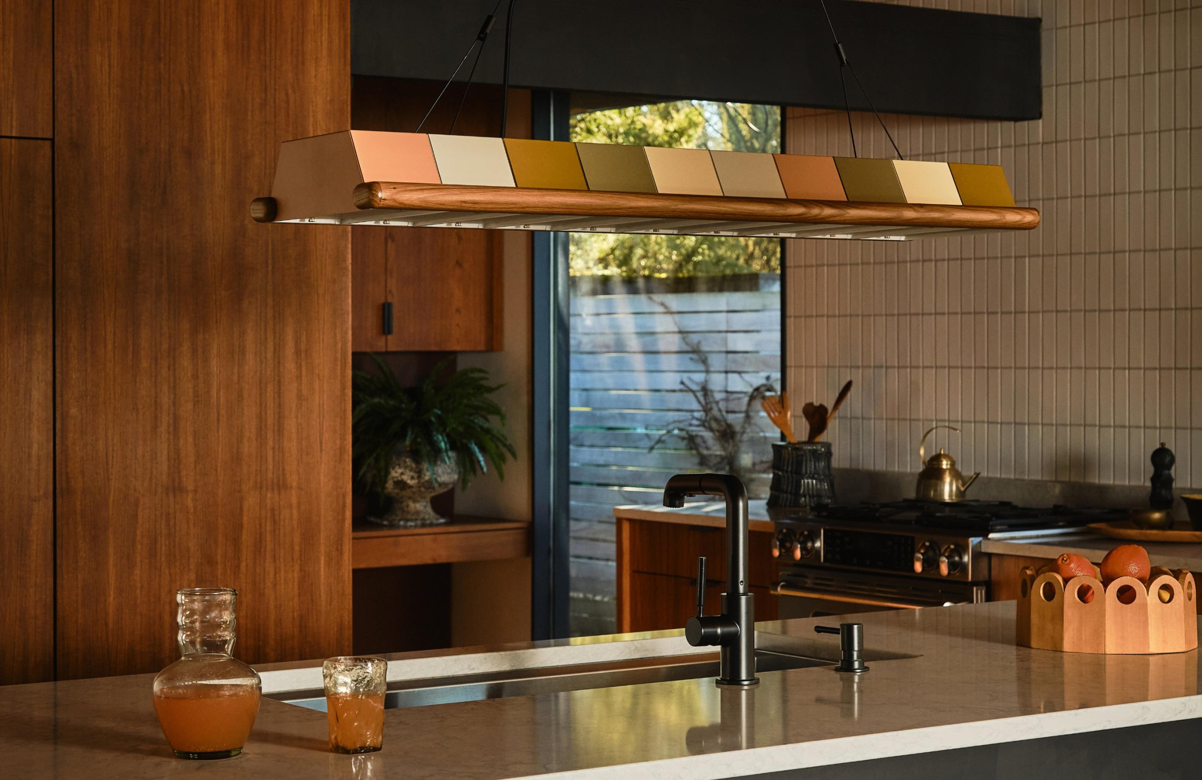 Multi color linear chandelier over kitchen island
