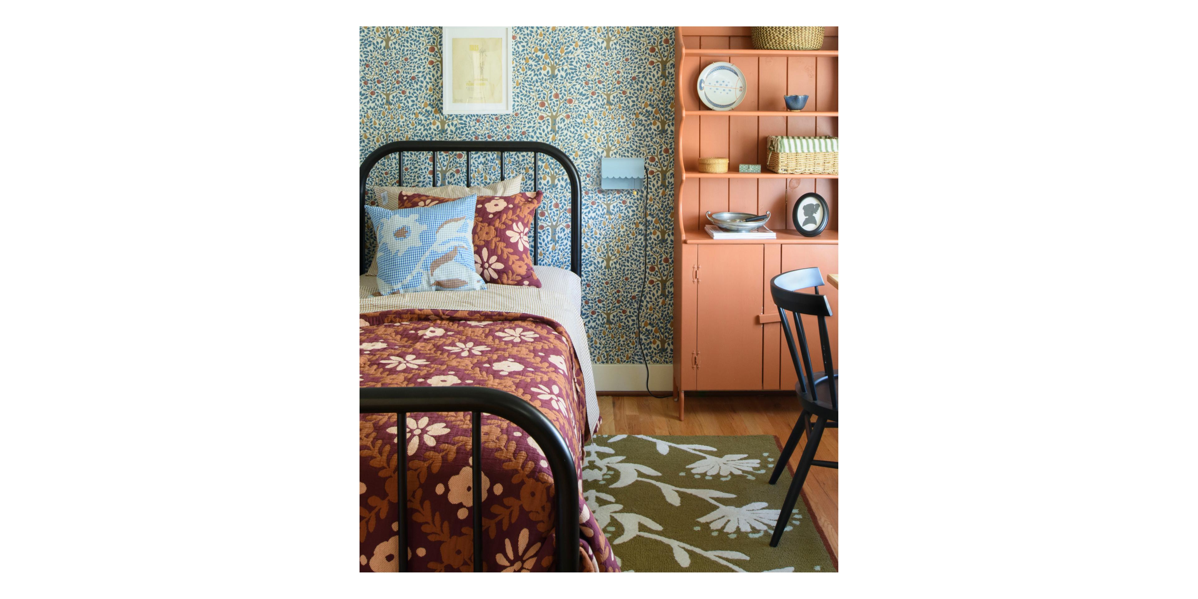 Child's room with blue and green wallpaper and pink shelf.