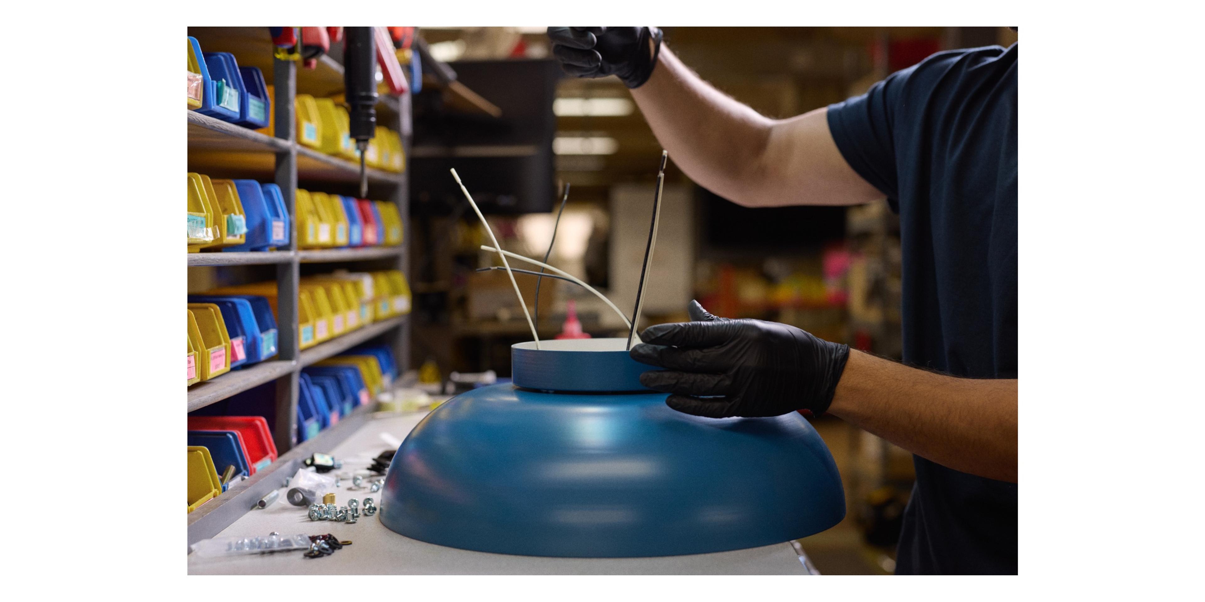 blue lighting fixture being assembled and wired 