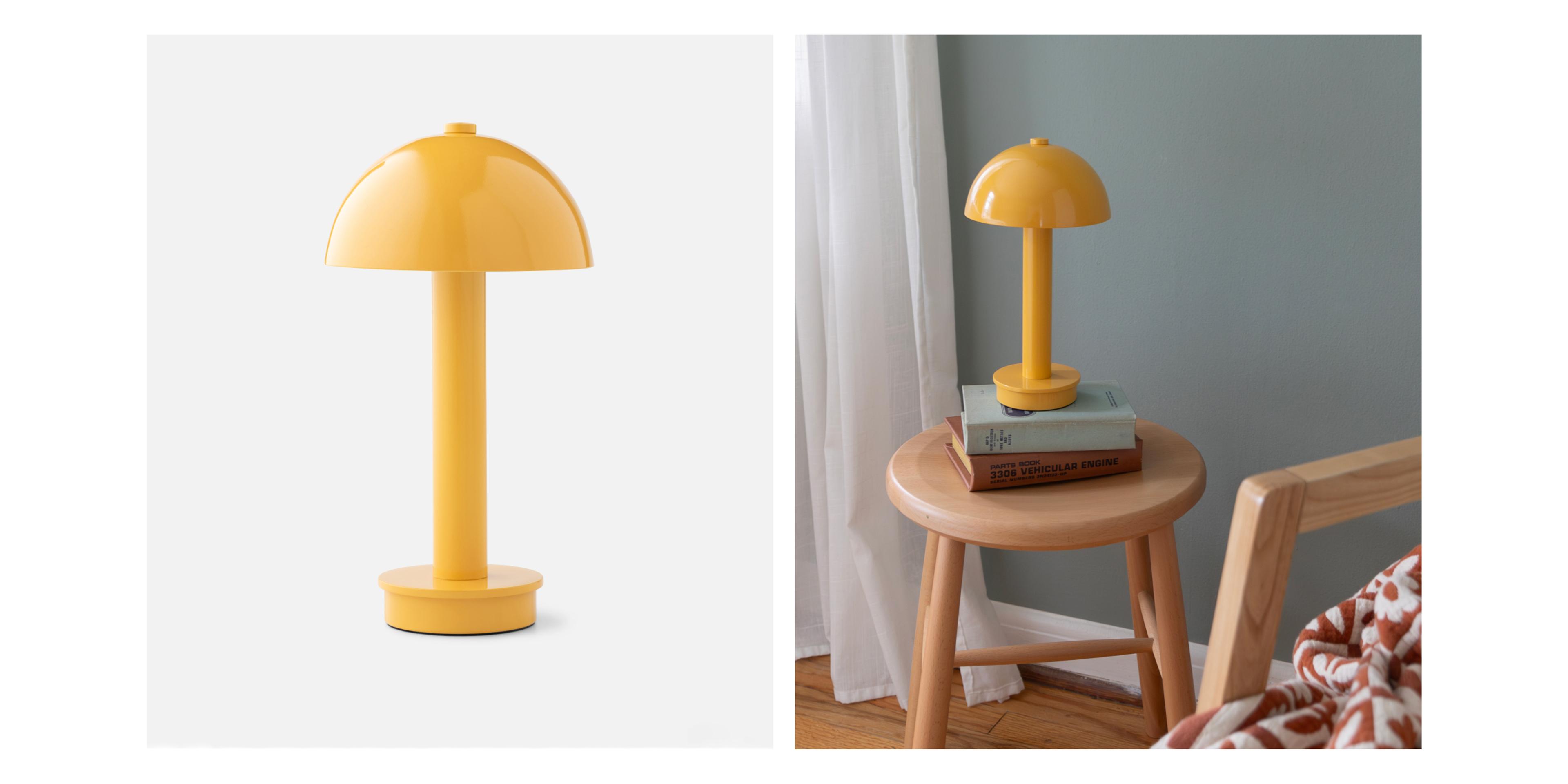 yellow portable lamp on a stack of books