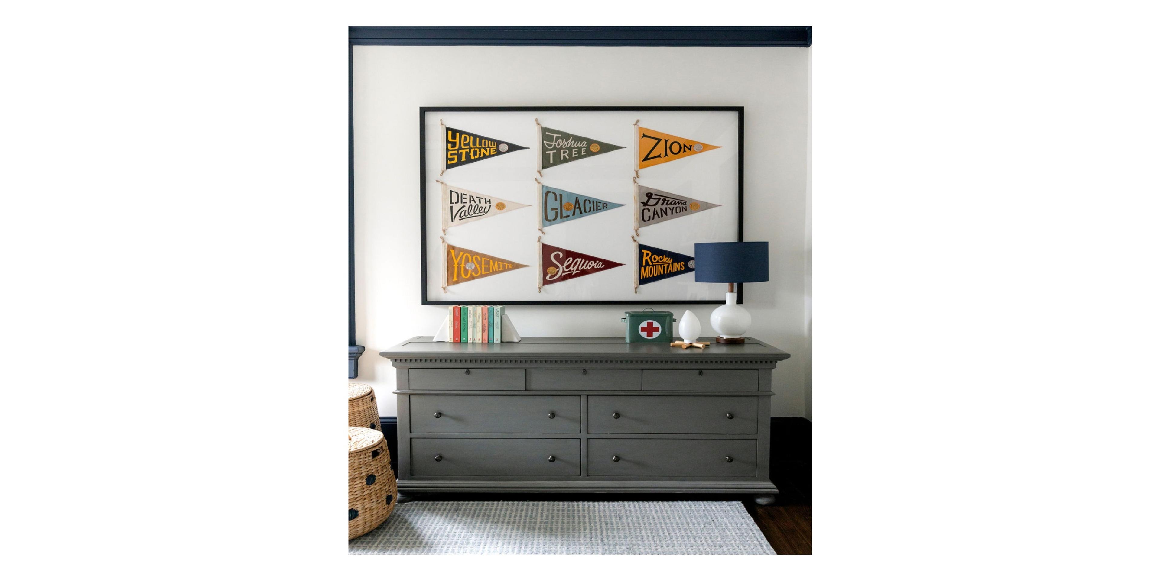 Dresser with pennants framed above it.