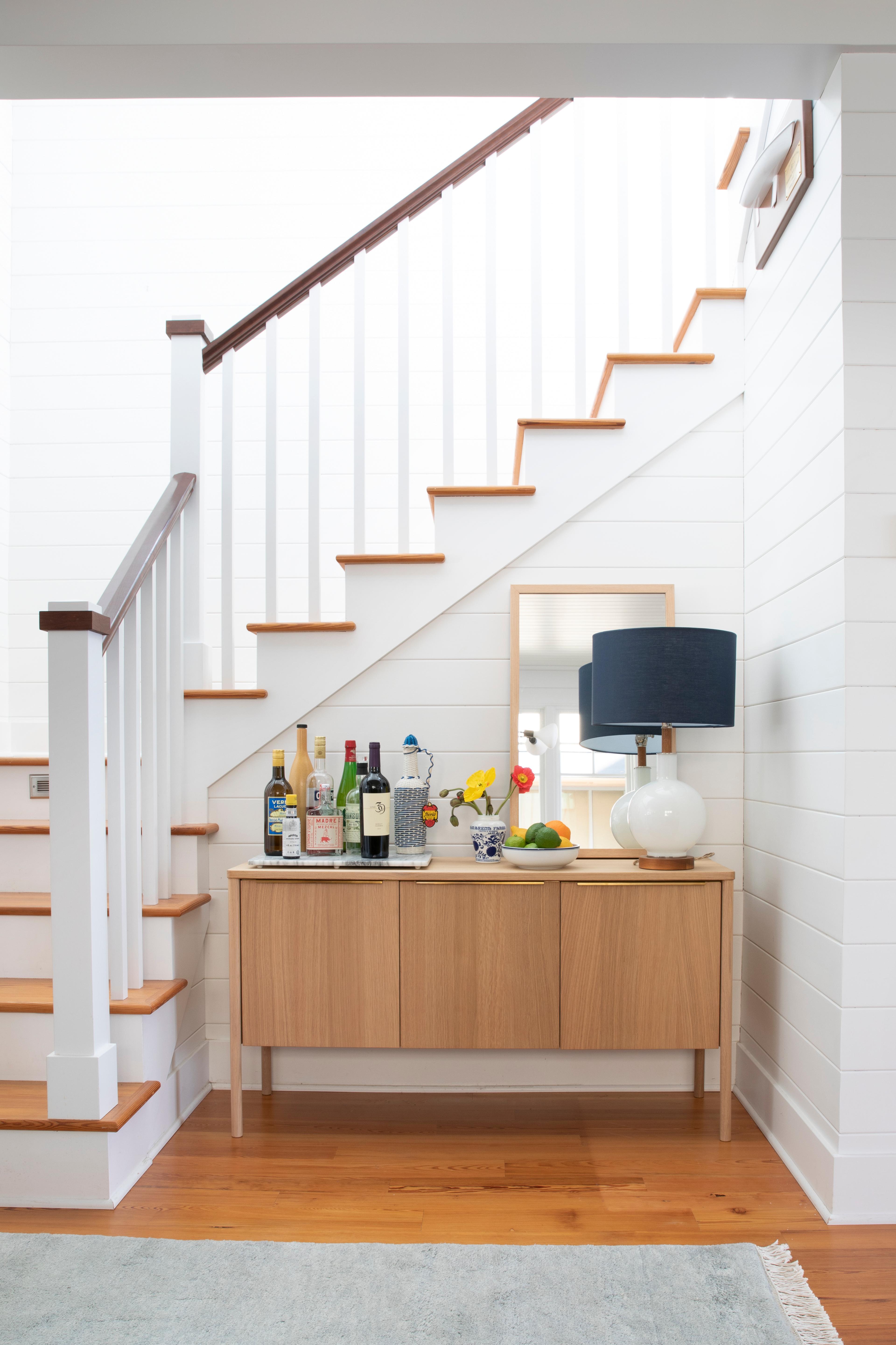 Sideboard in front of staircase.