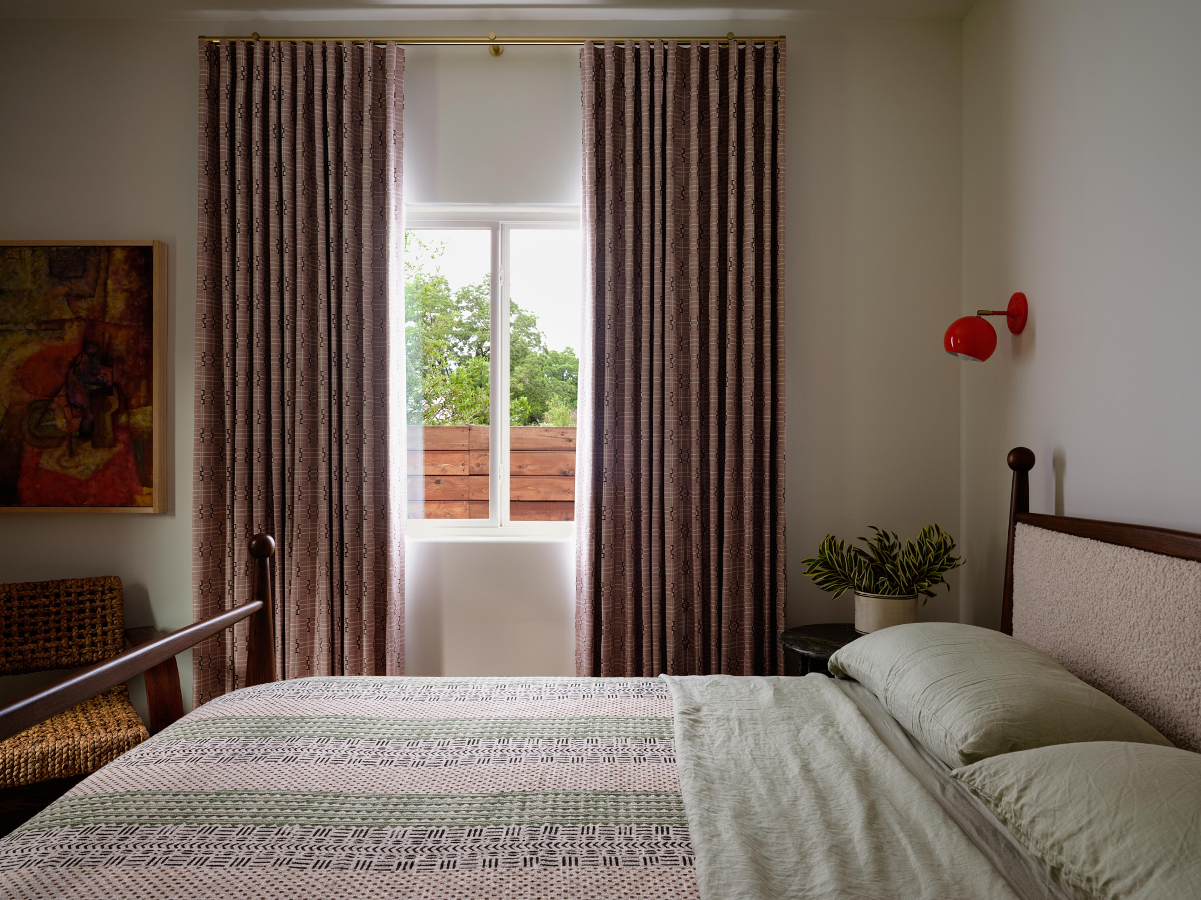 Red sconce in a white bedroom.