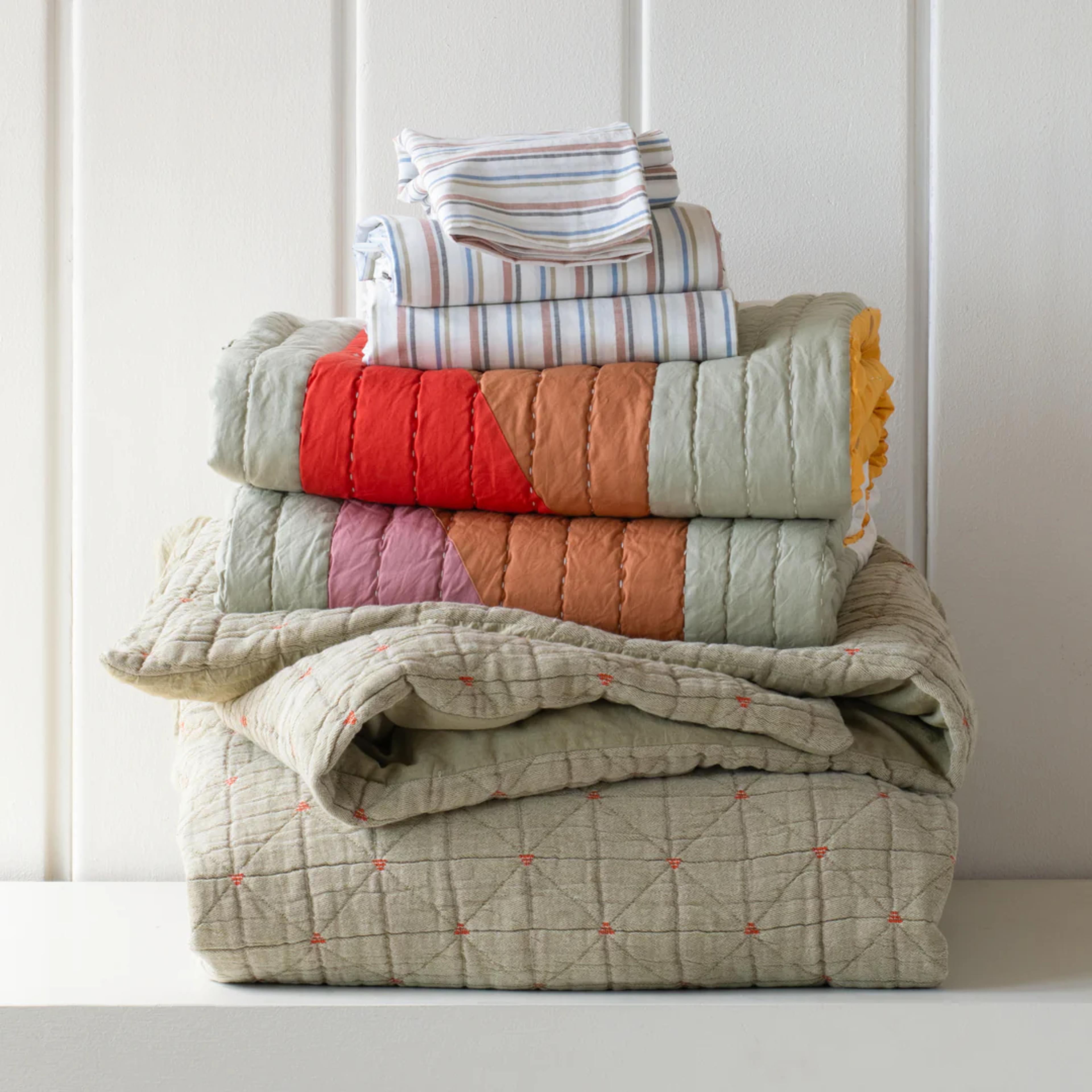 Bedding stack with colorful bedding.