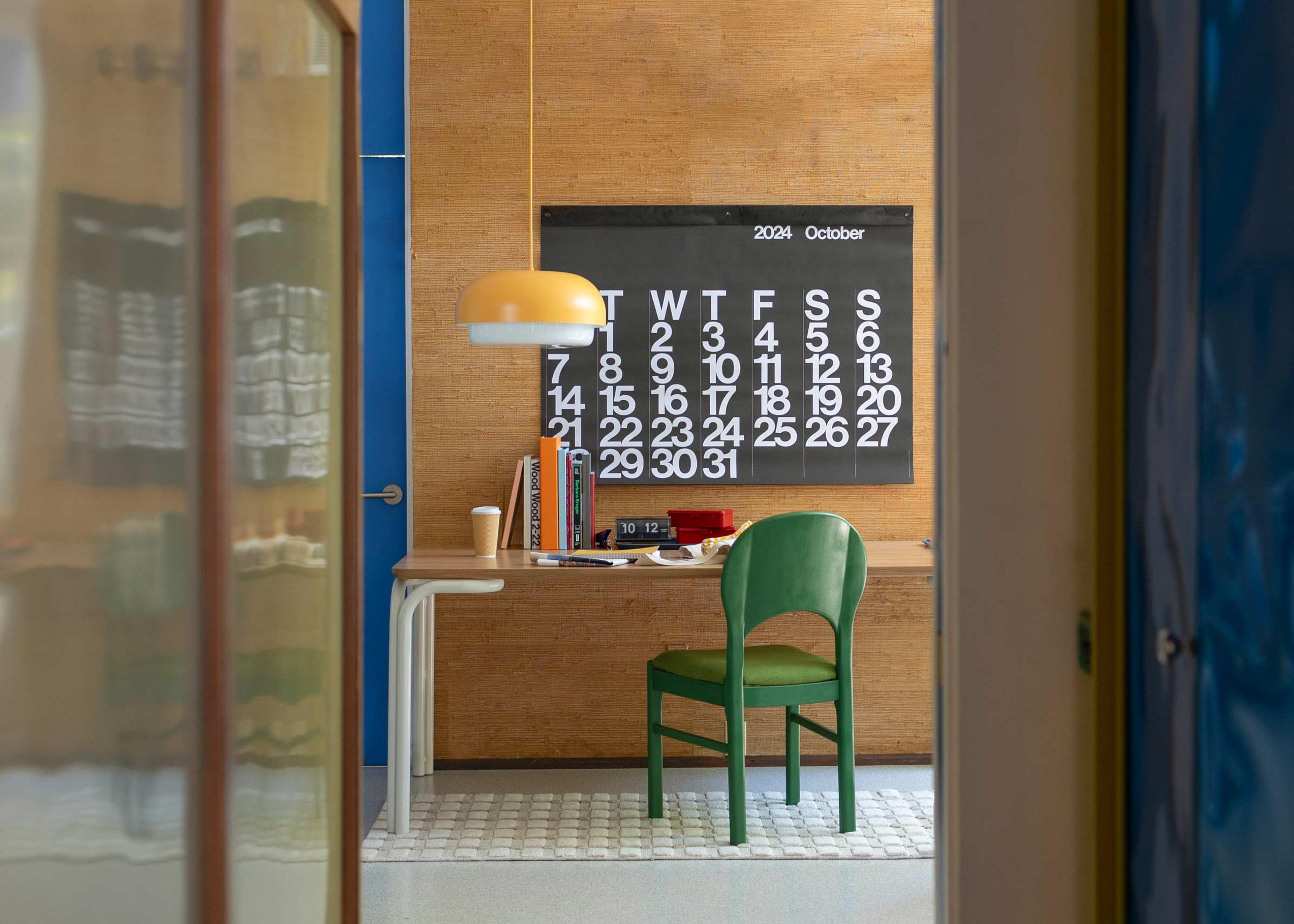 A green accent chair in a home office. 