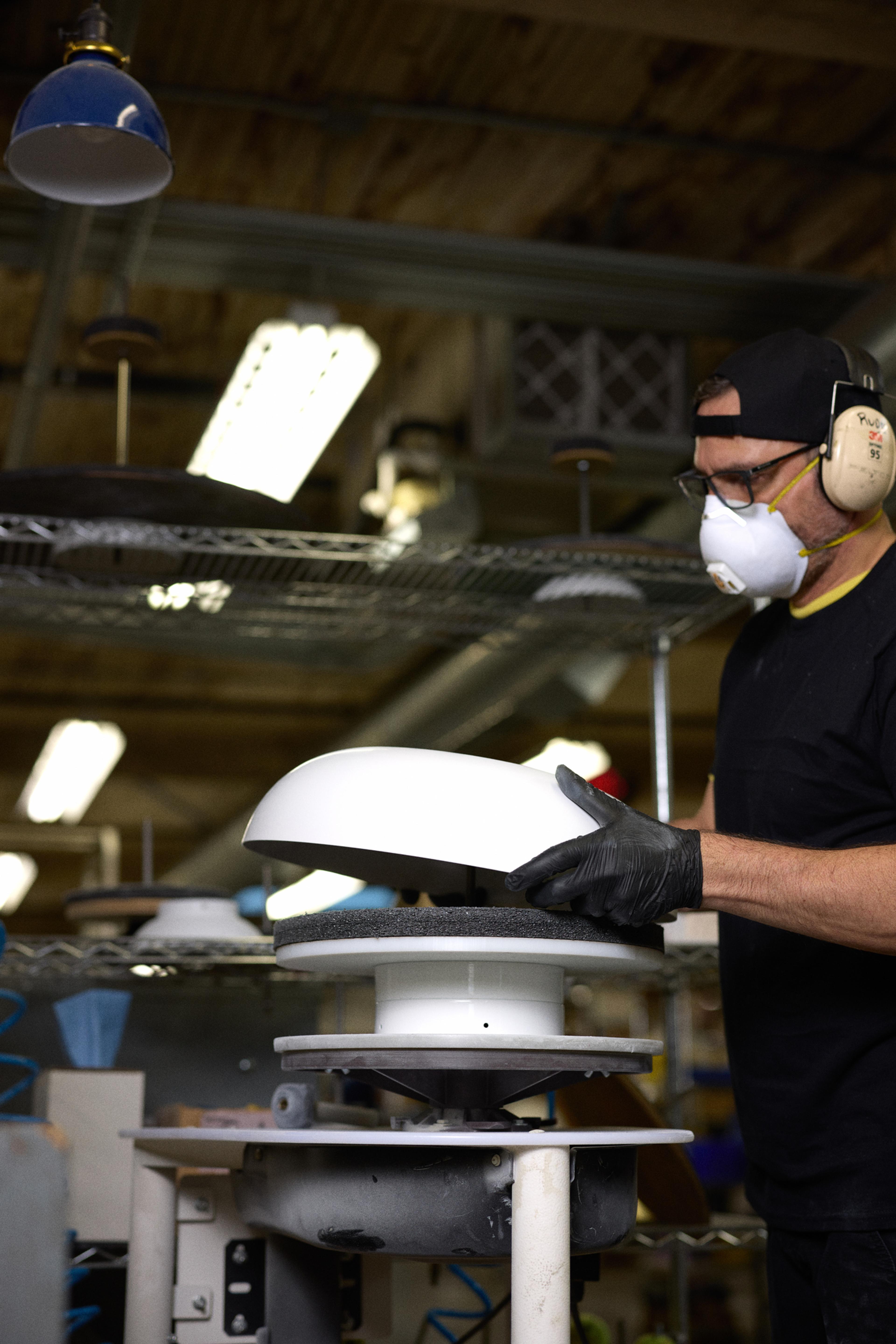 Person picking up light fixture shade