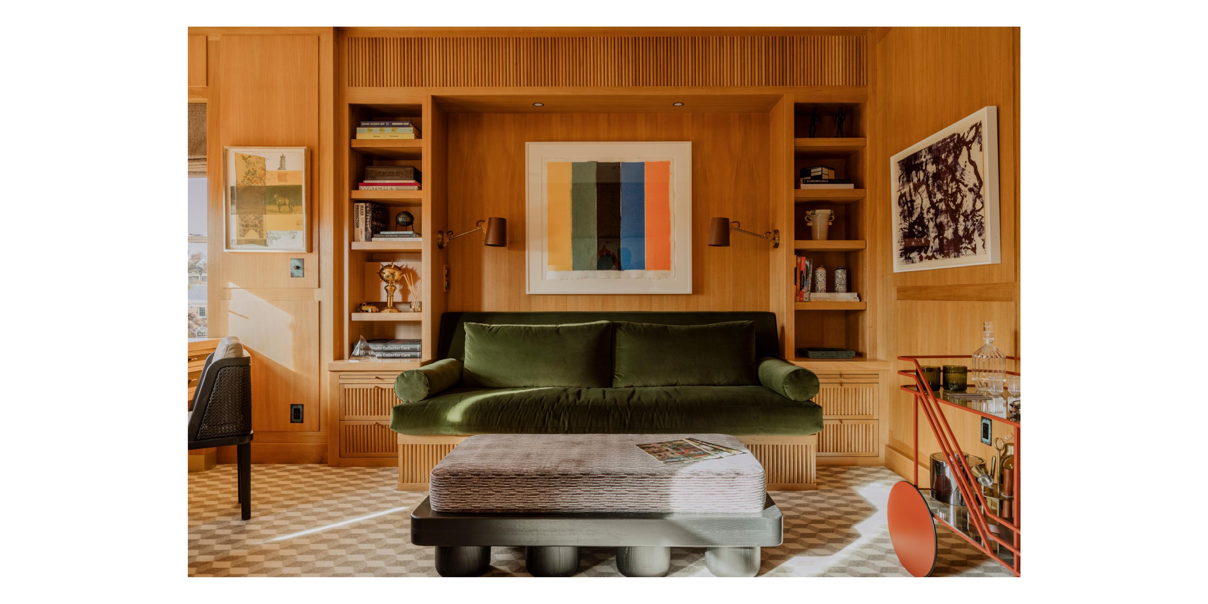 wood paneled living room with velvet green couch