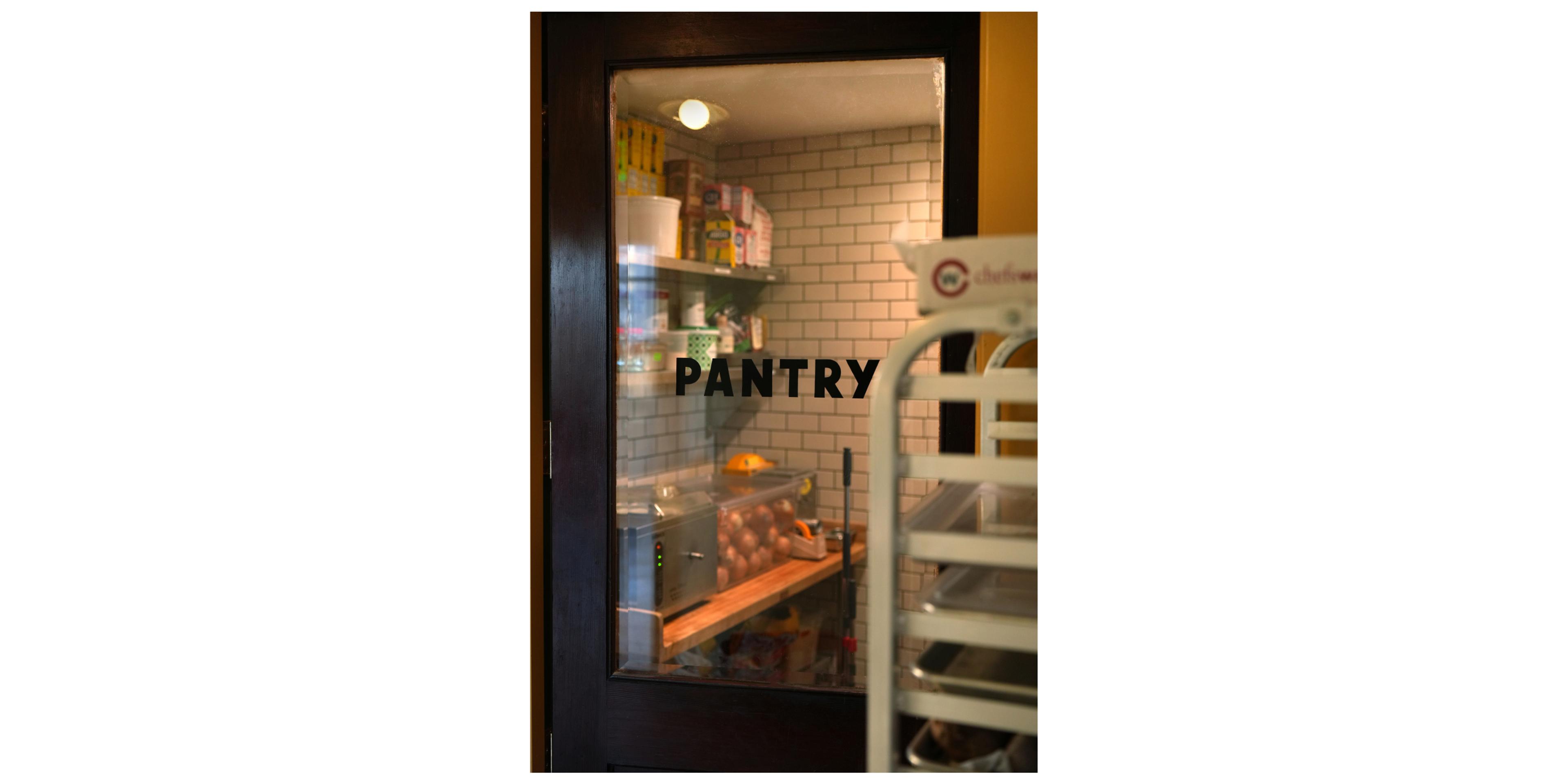 class pane door with black letters spelling out Pantry