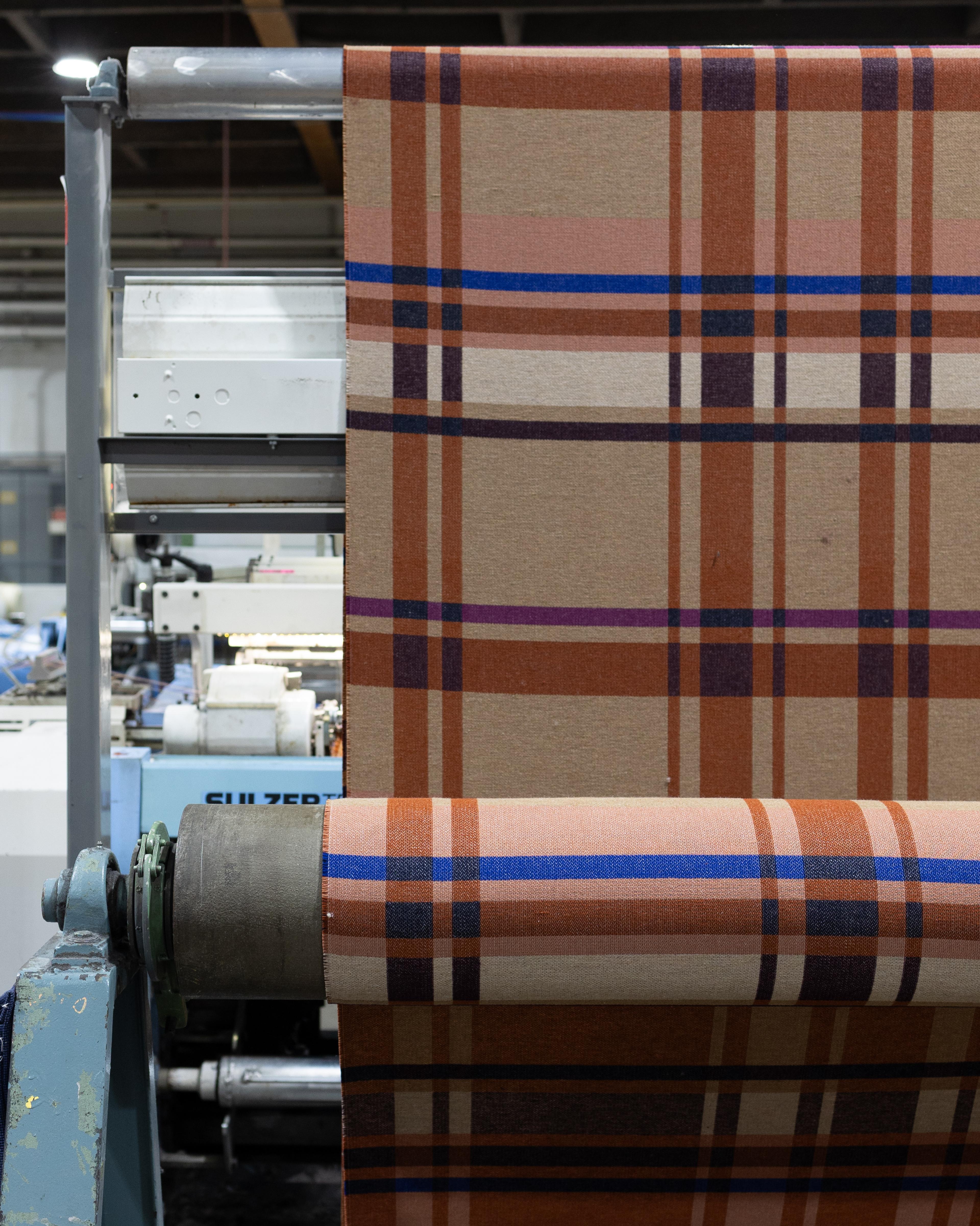 BTS of plaid blanket being made.