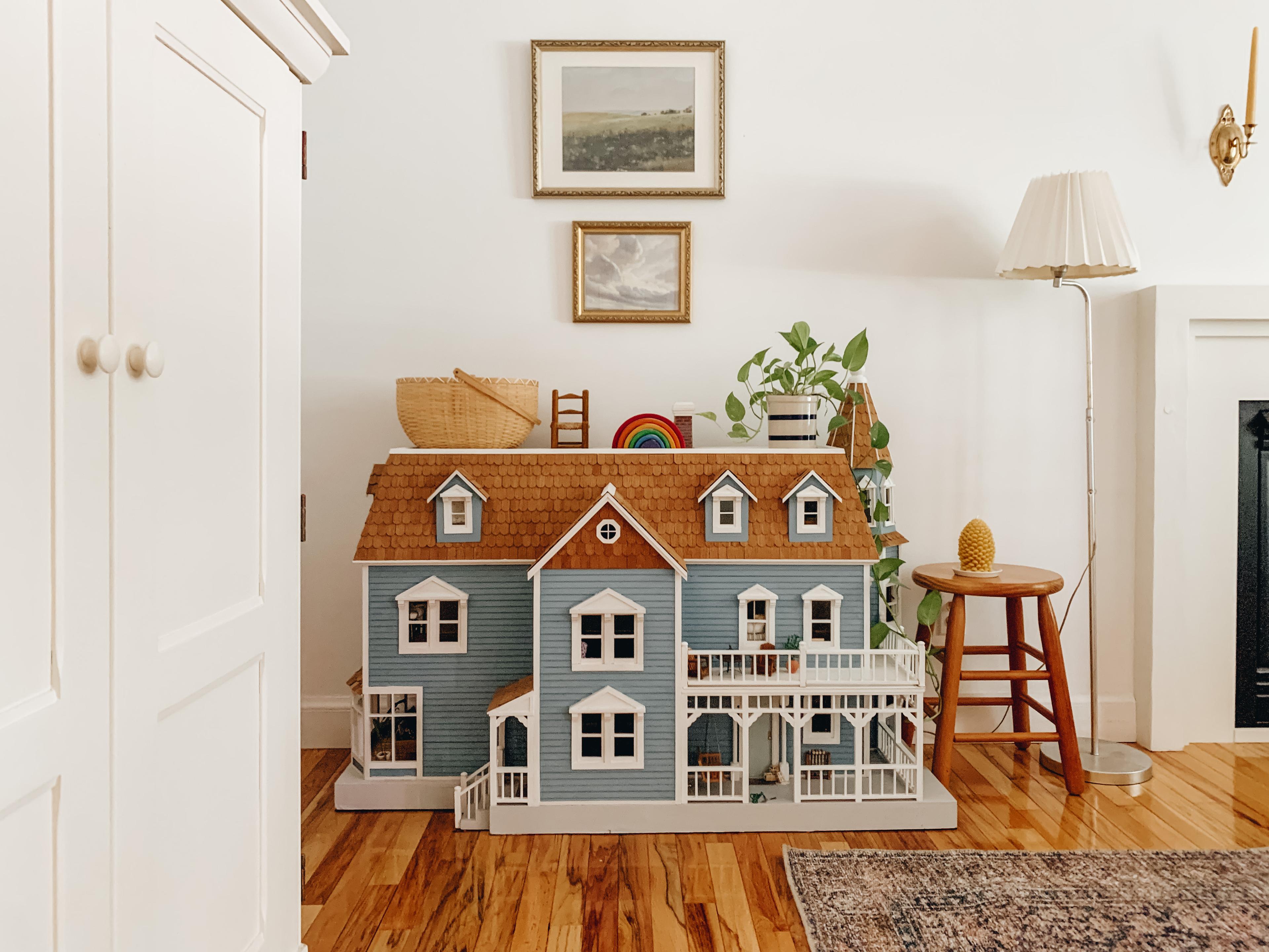 Big blue dollhouse in living room. 