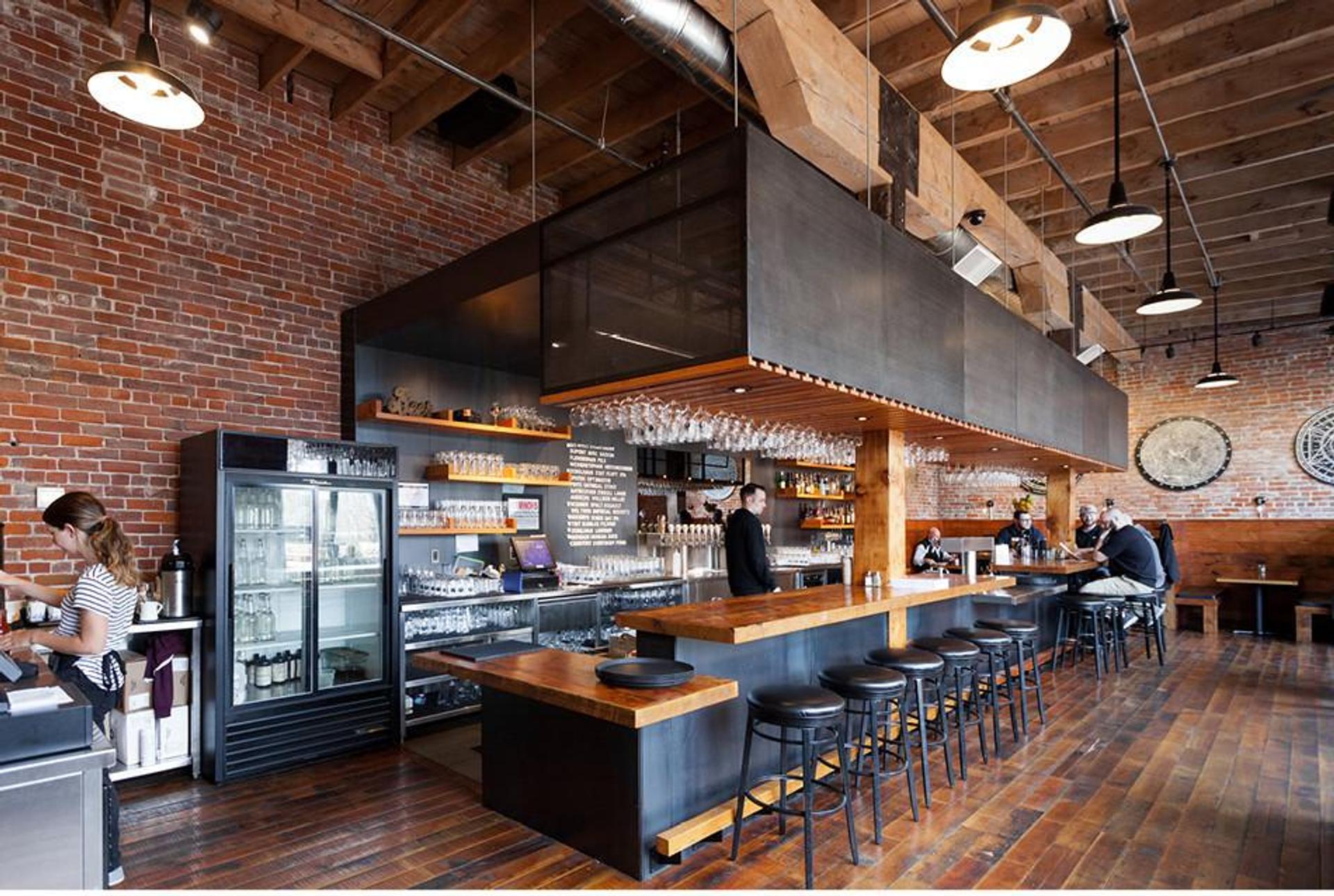 restaurant with a bar and a brick wall