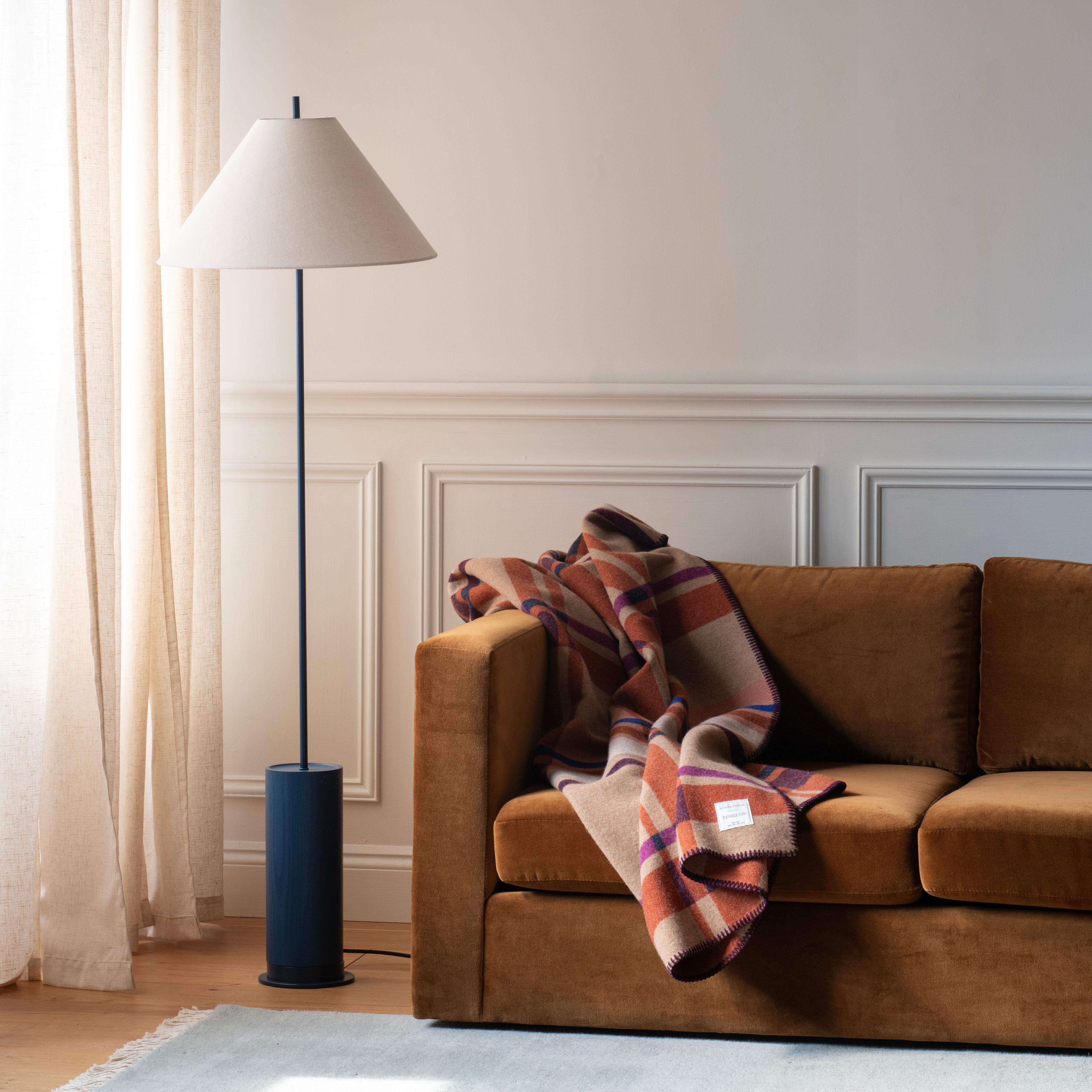 Plaid blanket on a sofa.