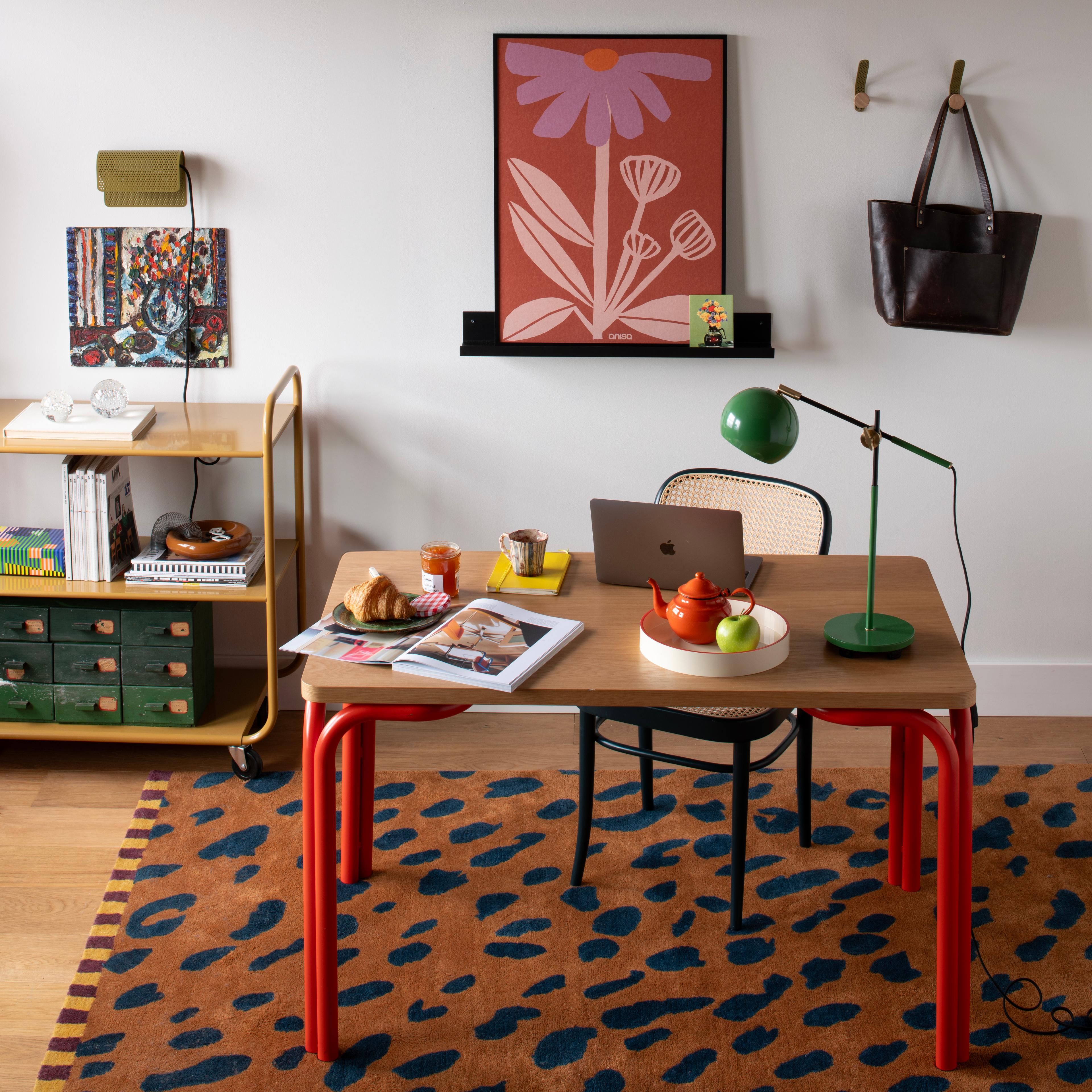 Office with leopard carpet and green table lamp