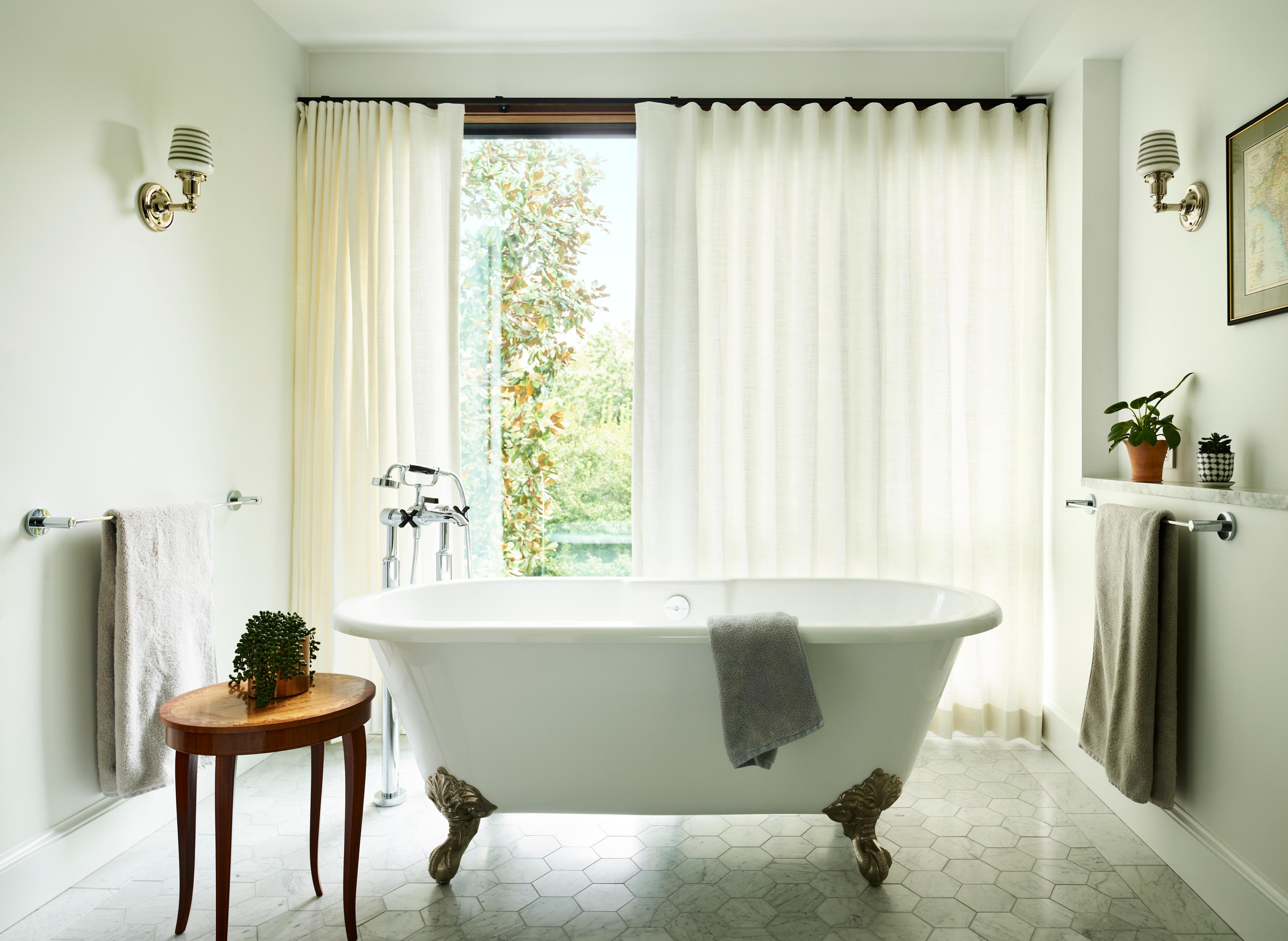 Bathtub in middle of bathroom. 