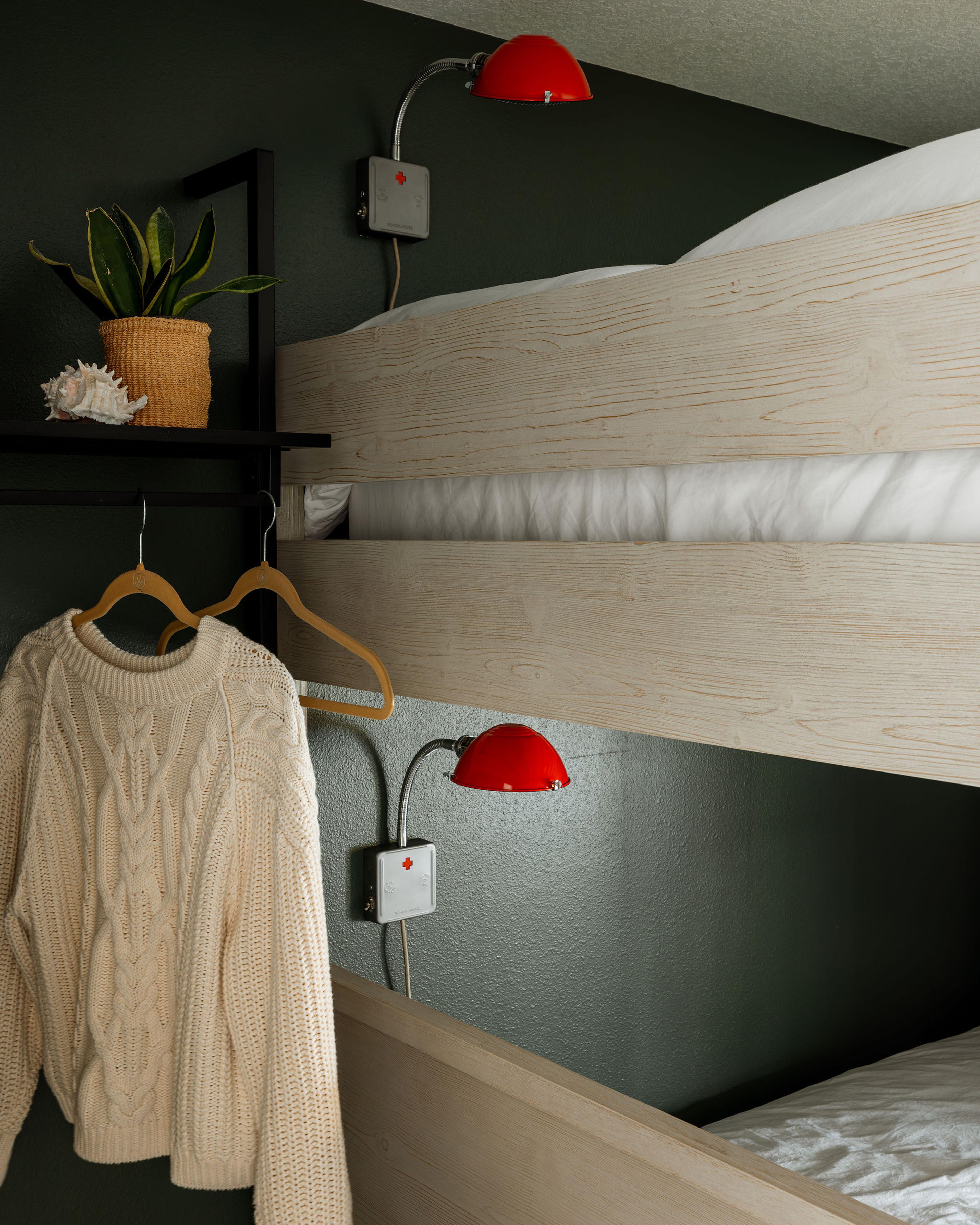 Sconces by bunk beds.