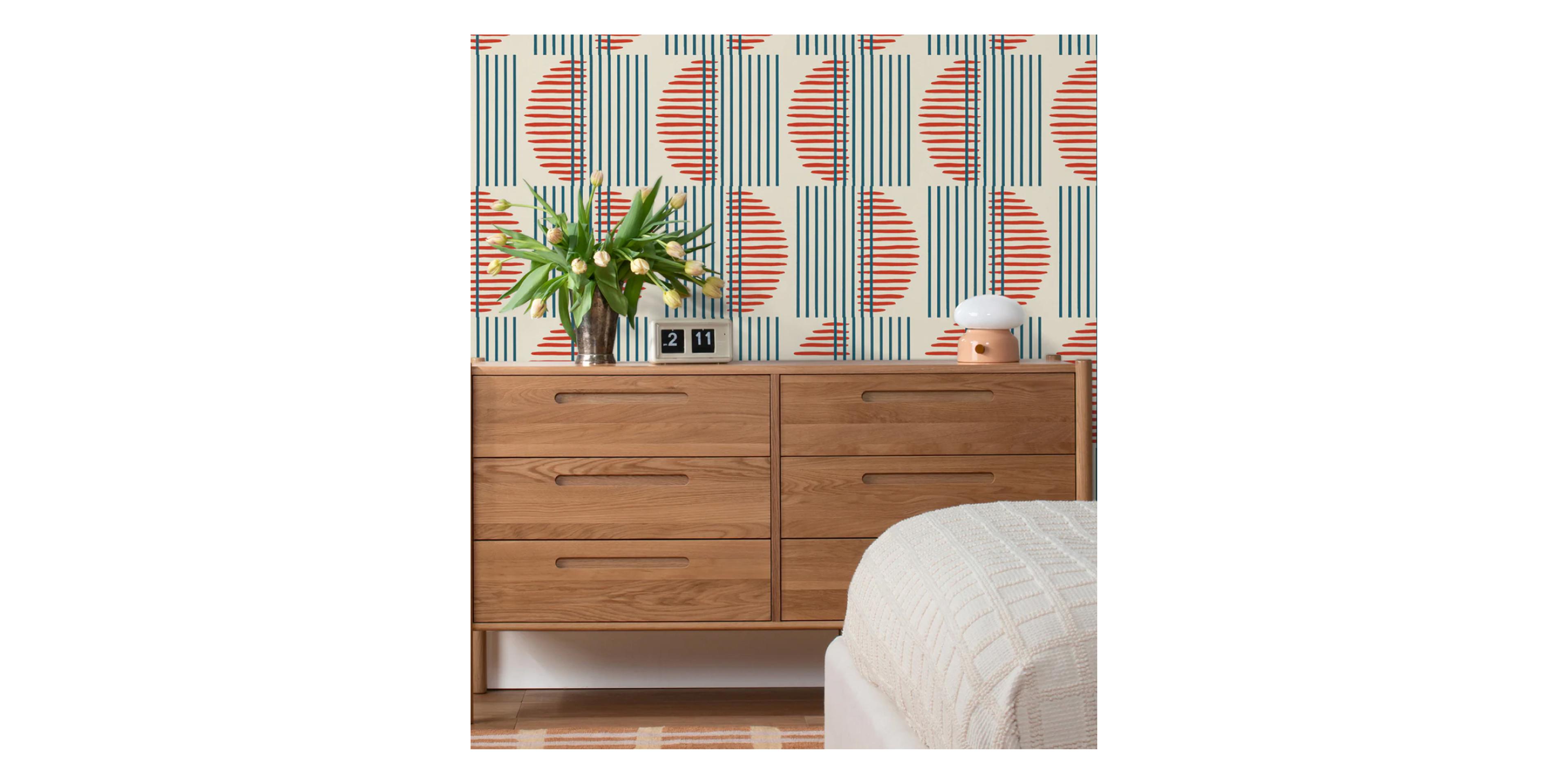 Funky wallpaper with oak dresser.