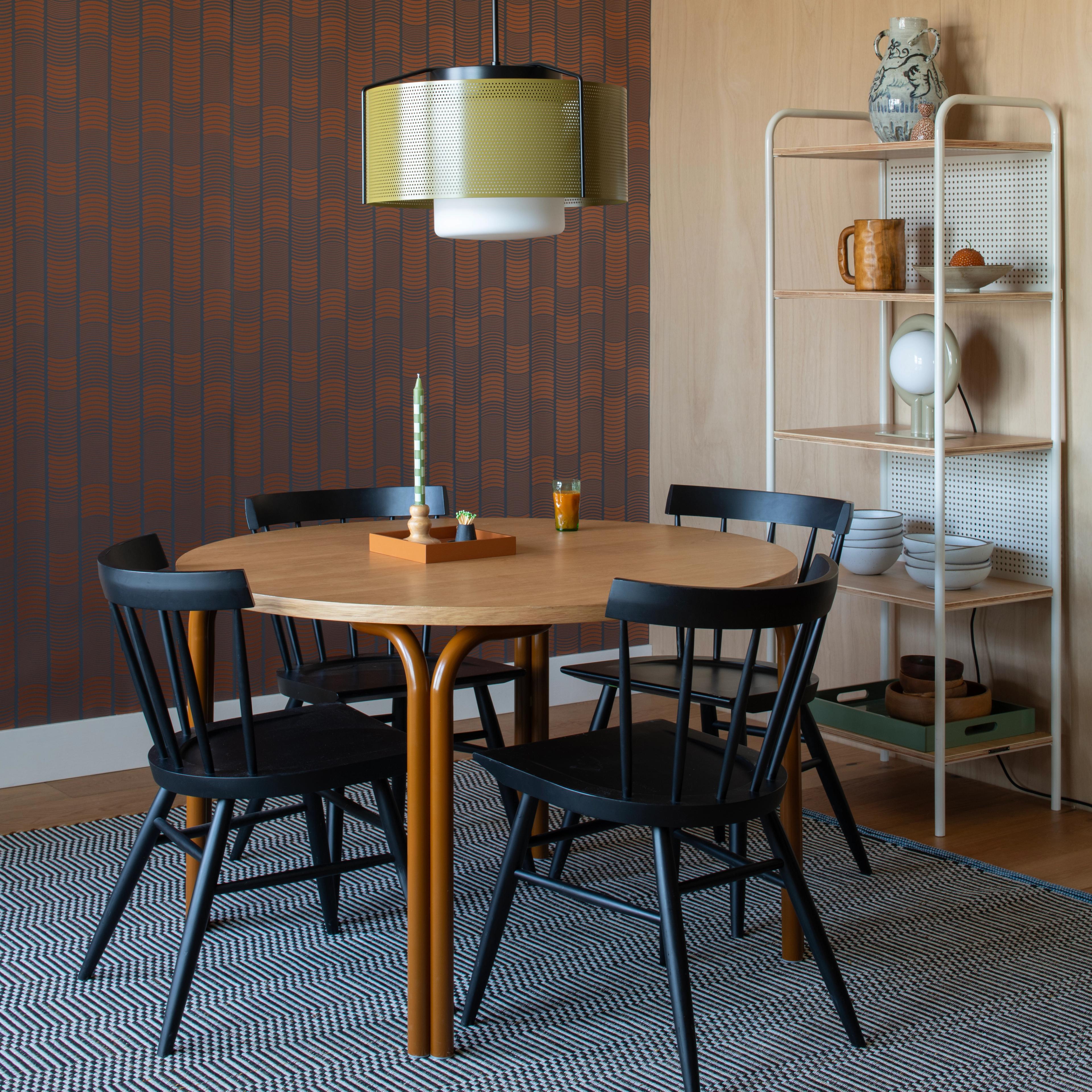 green perforated pendant above dining table