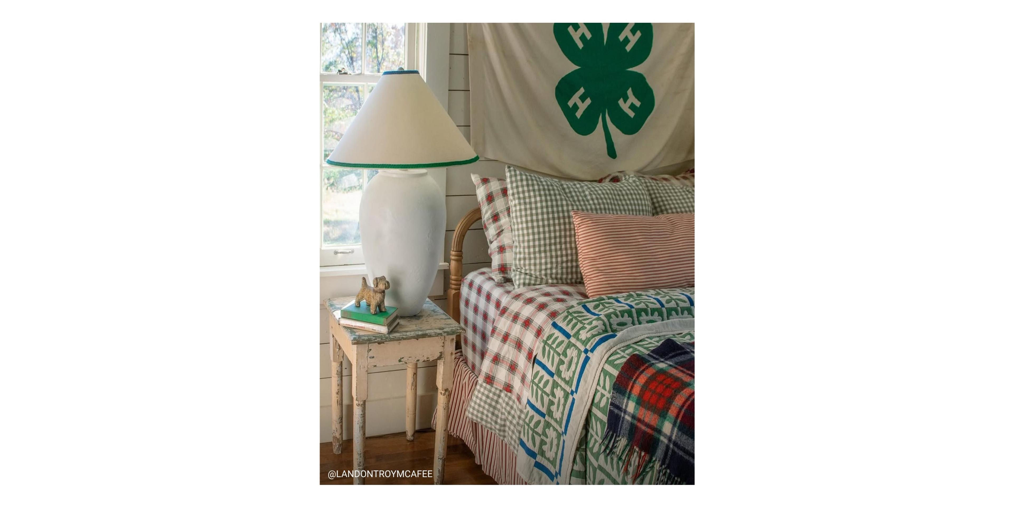 Rustic bedroom with four leaf clover flag behind the bed. 