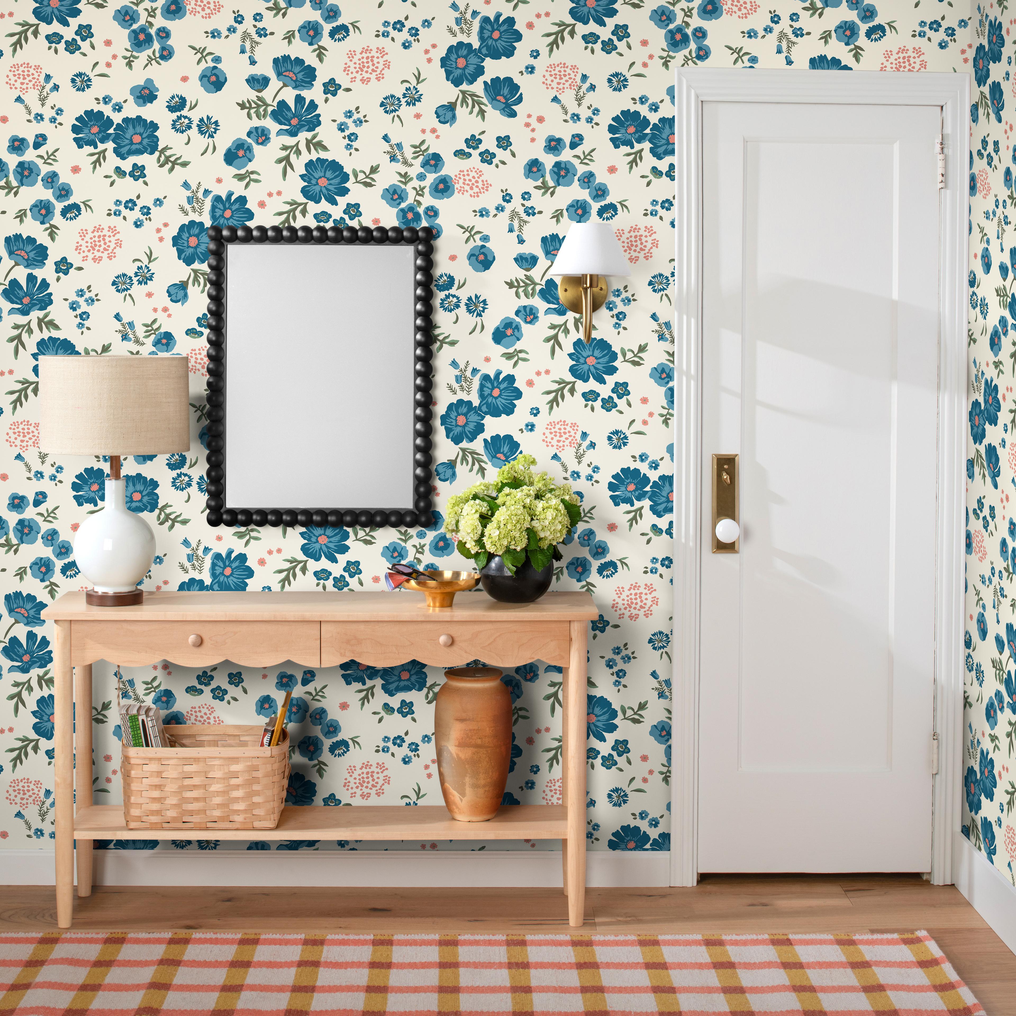 entry way with floral wallpaper, wooden sideboard and plaid runner 