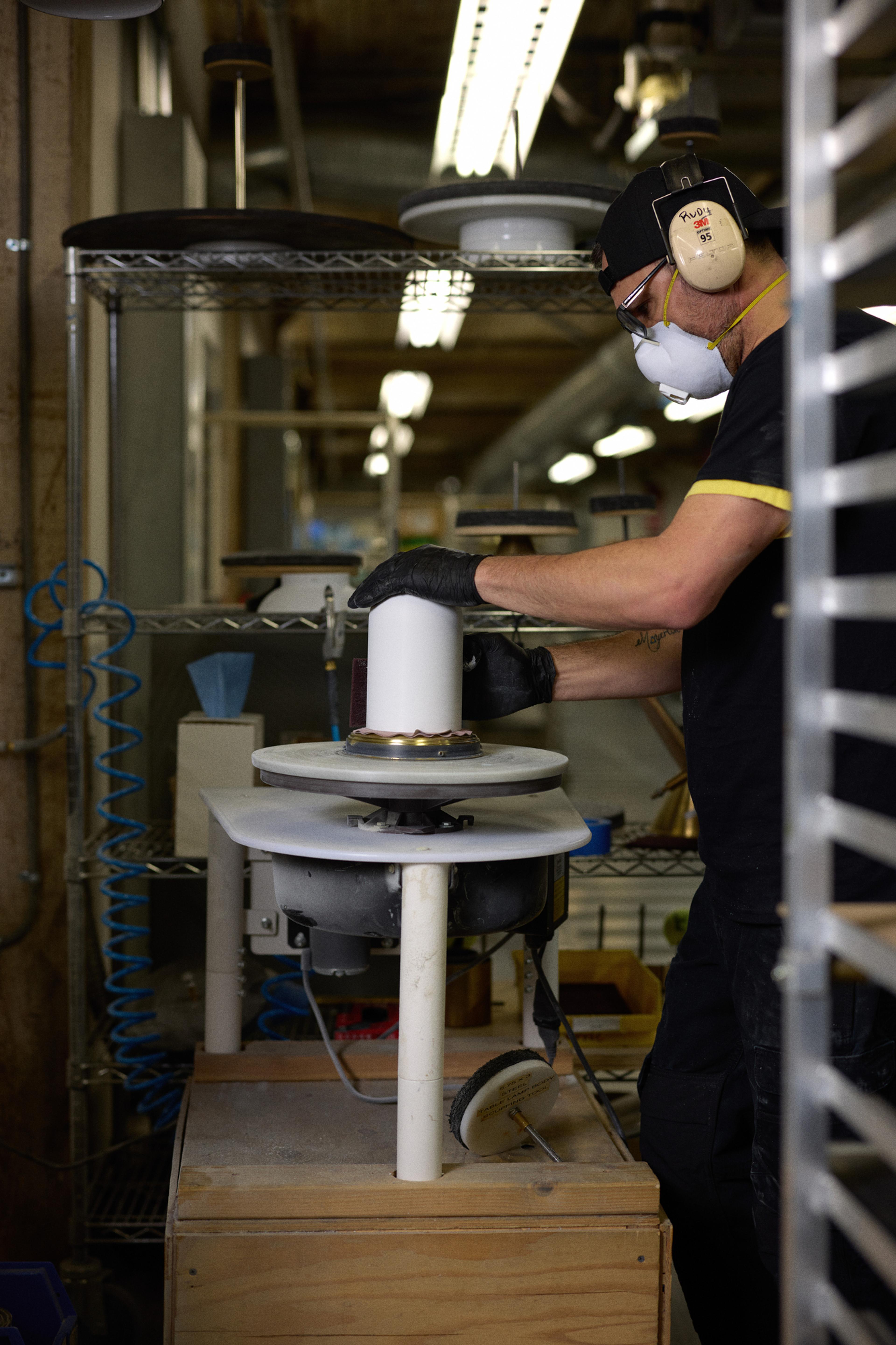 person sanding light shade