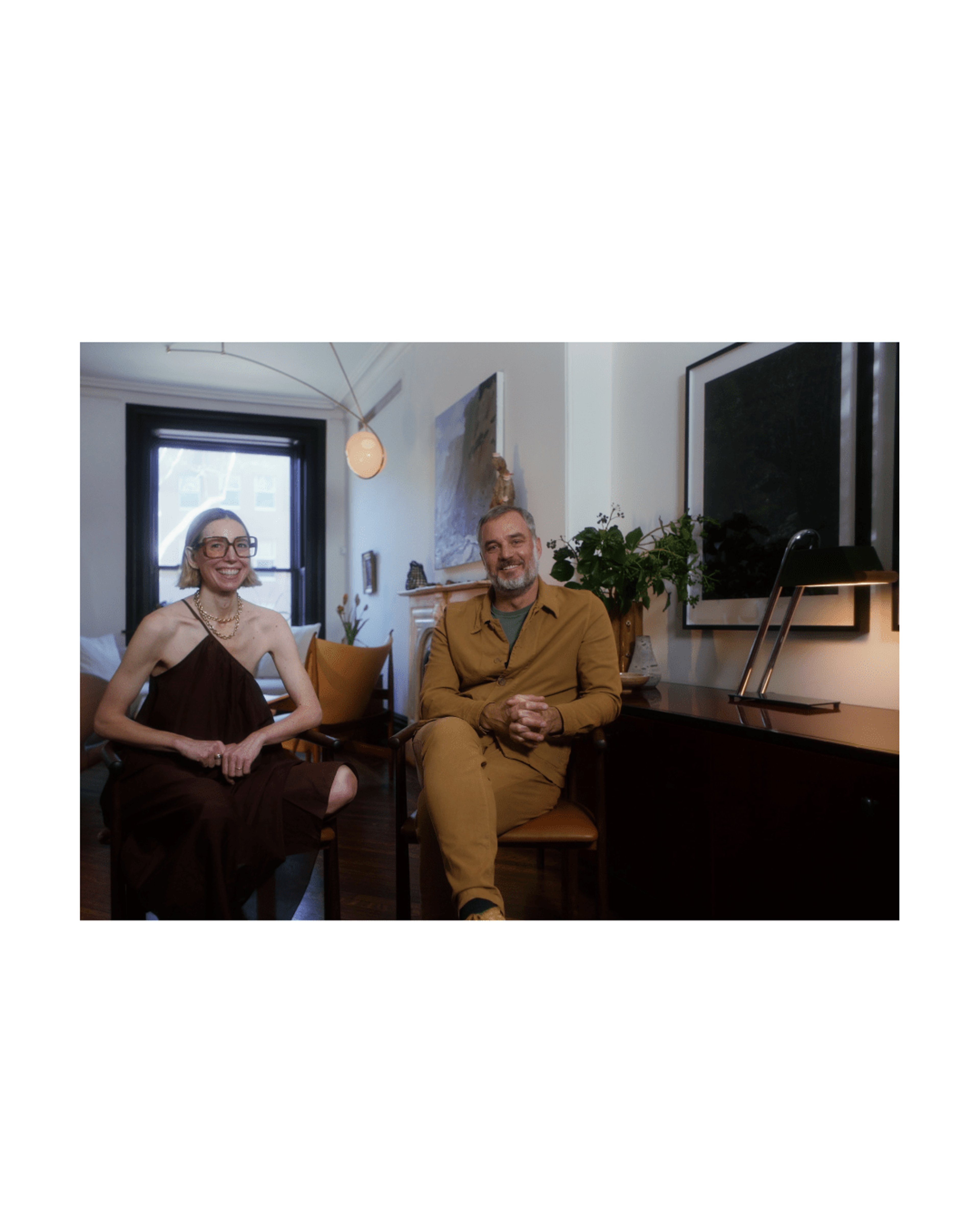 Frame of Erin & Jason smiling next to black and chrome table lamp