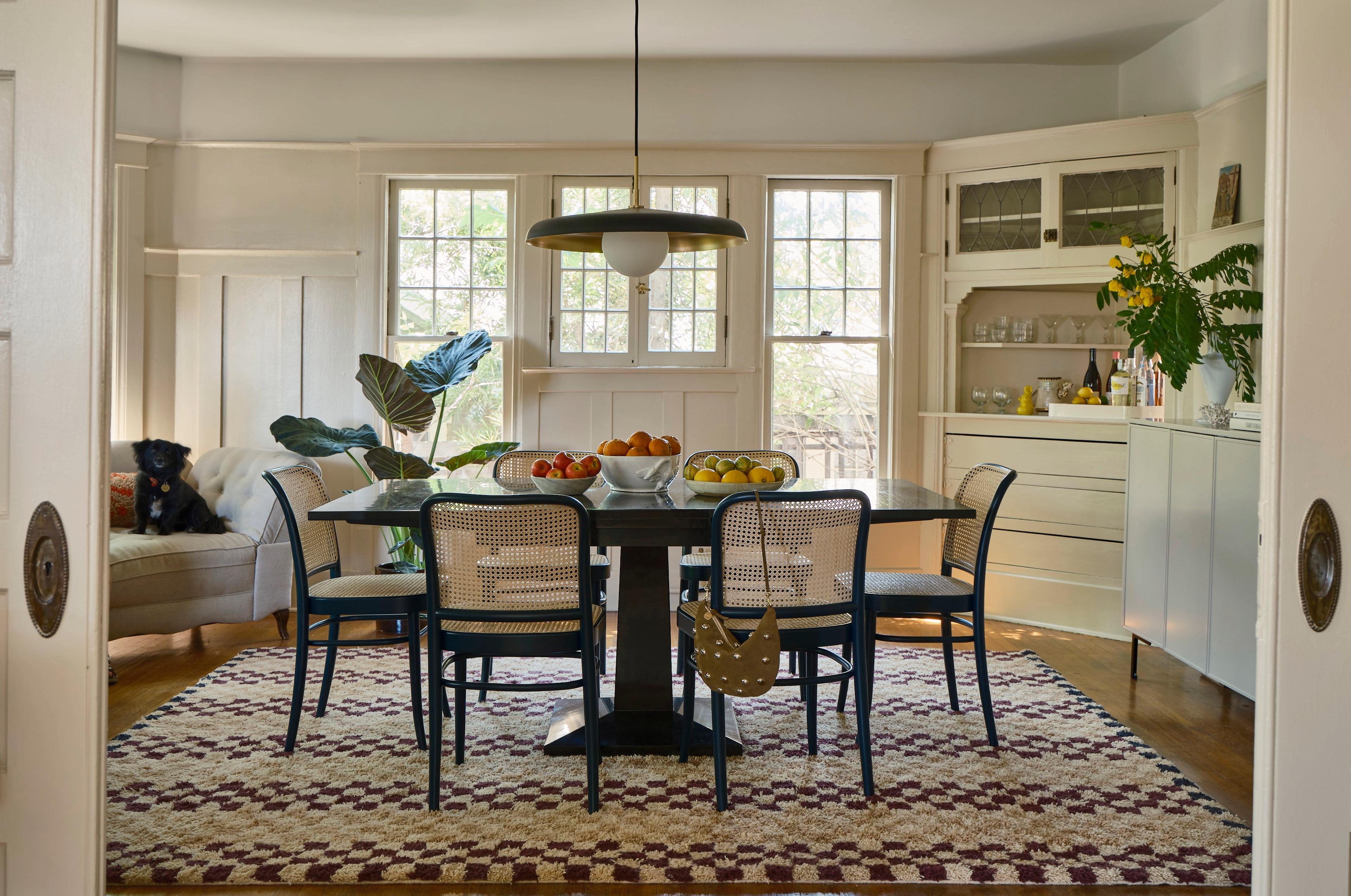 Modern dining room with pendant hanging over table and shag plaid rug in camel & rasin 