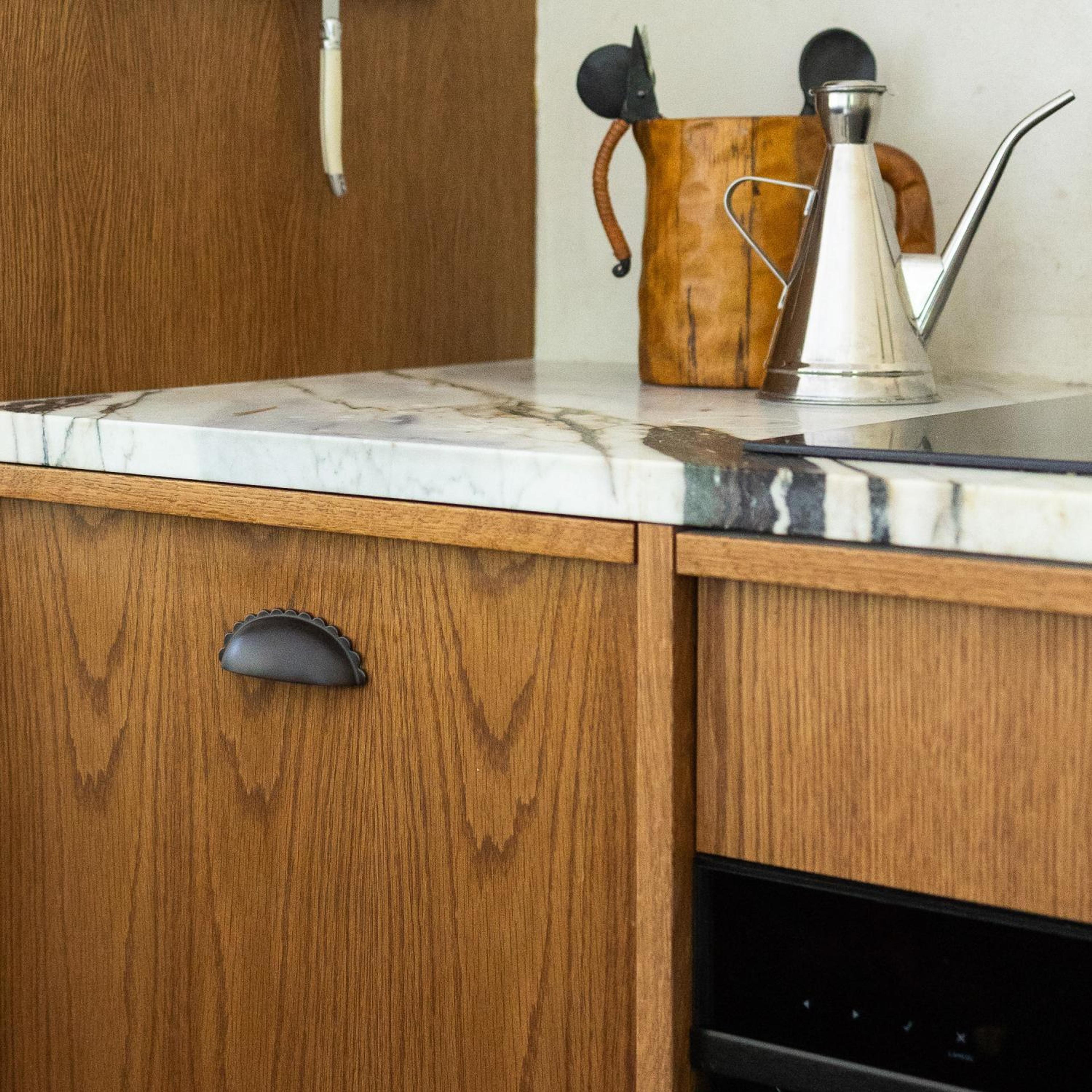 Marble kitchen counter with wooden cabinets below