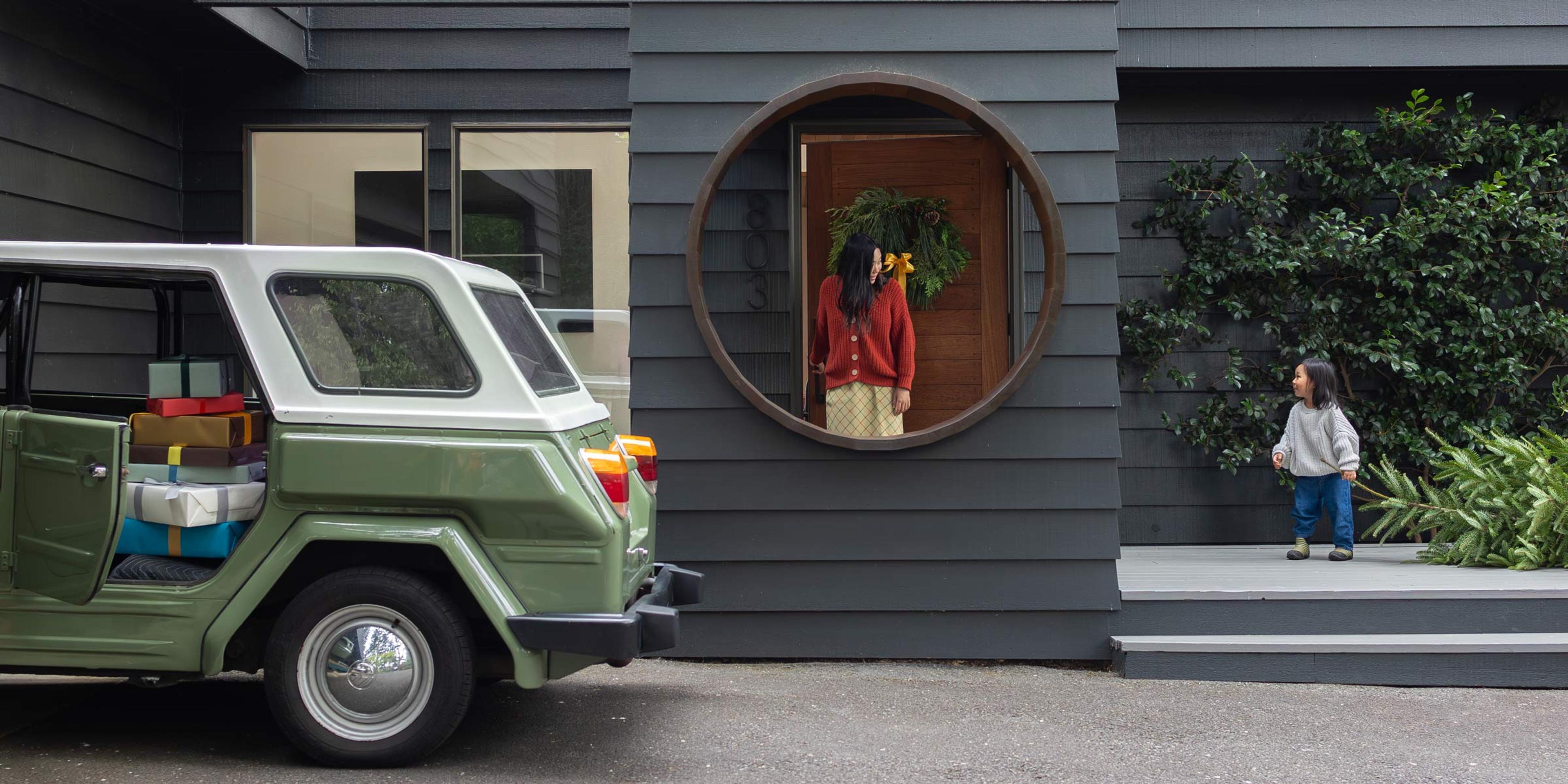 Outside of a holiday home with a woman and child. 