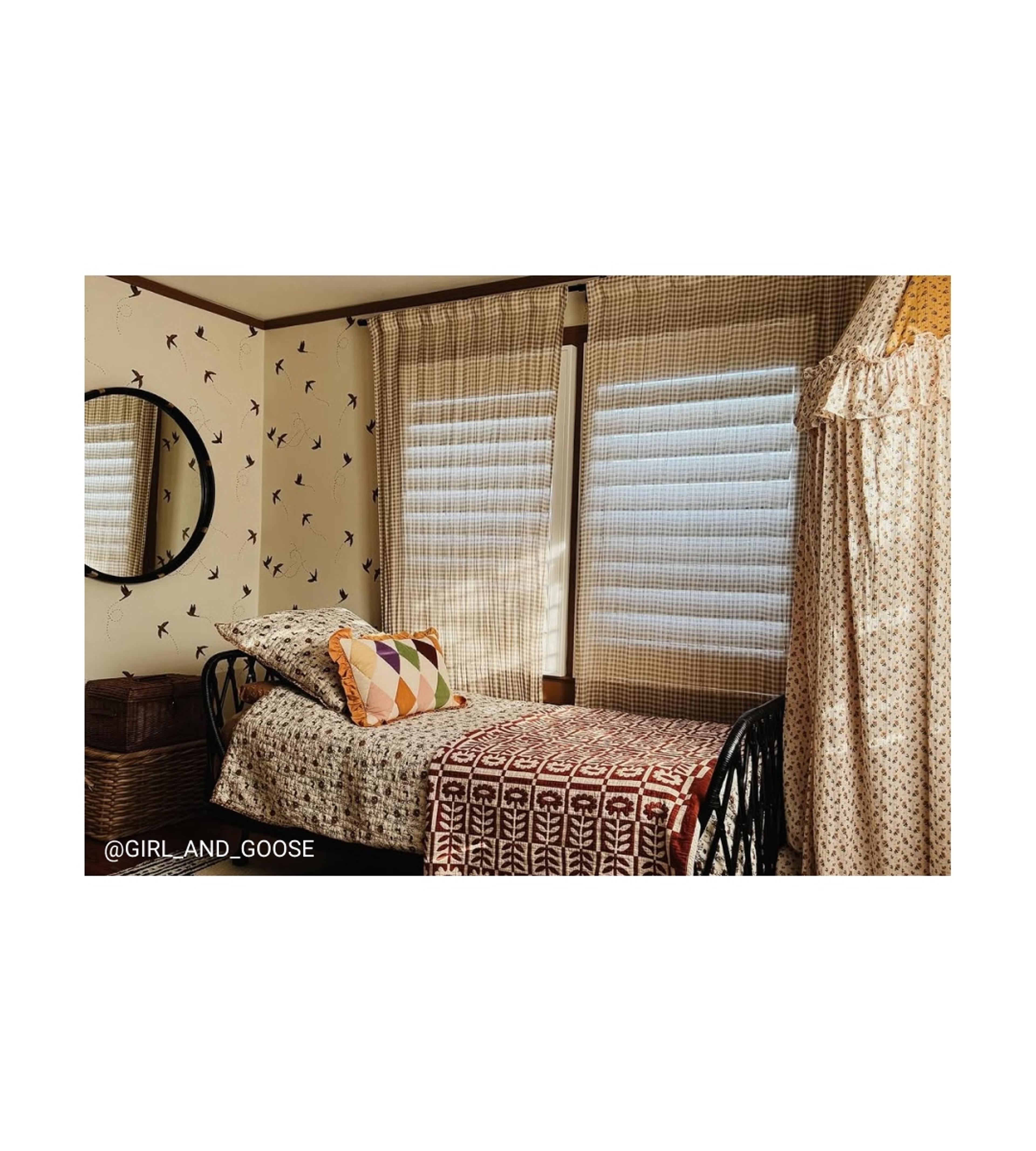 Eclectic bed with floral quilt. 