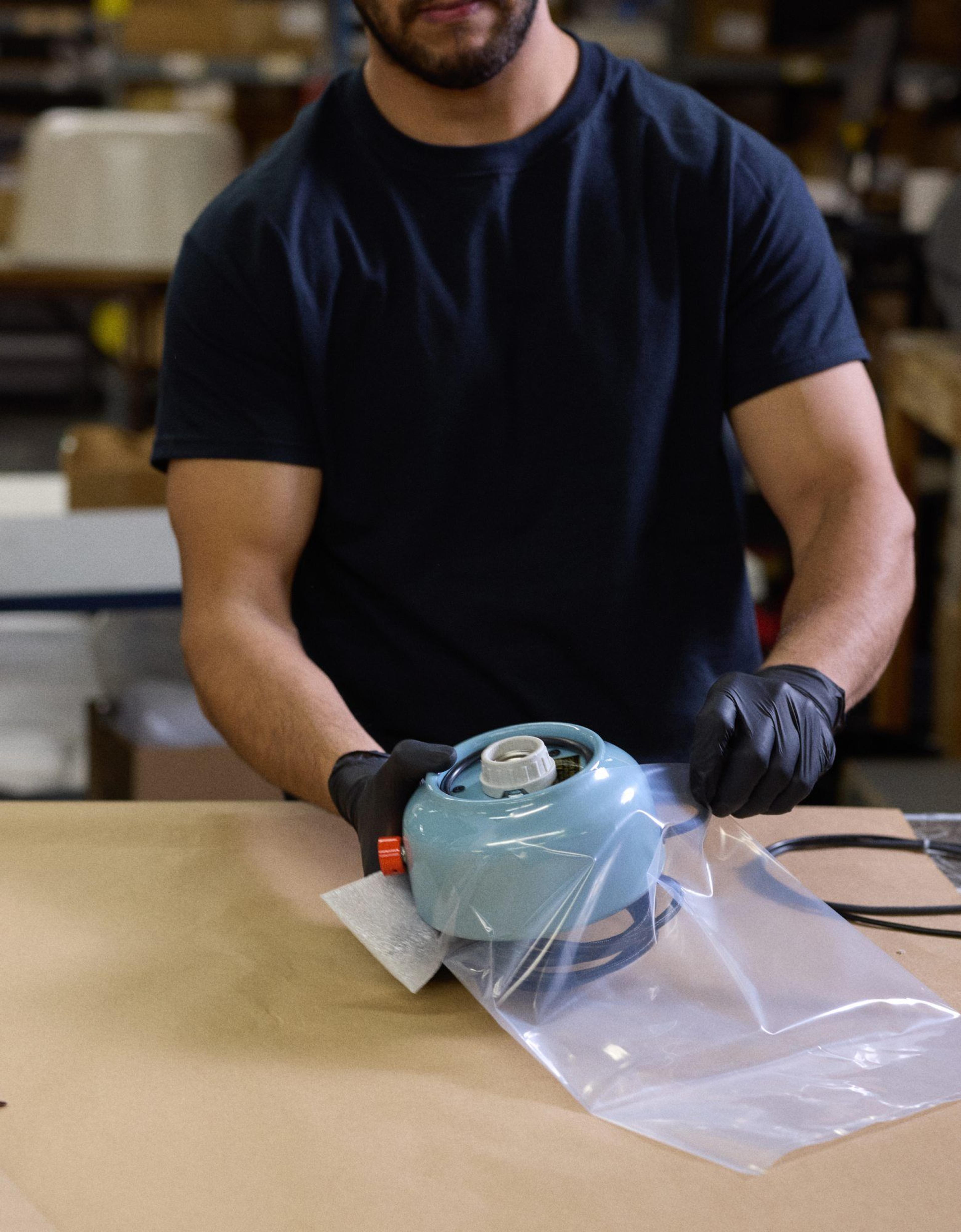 person packaging a teig lamp