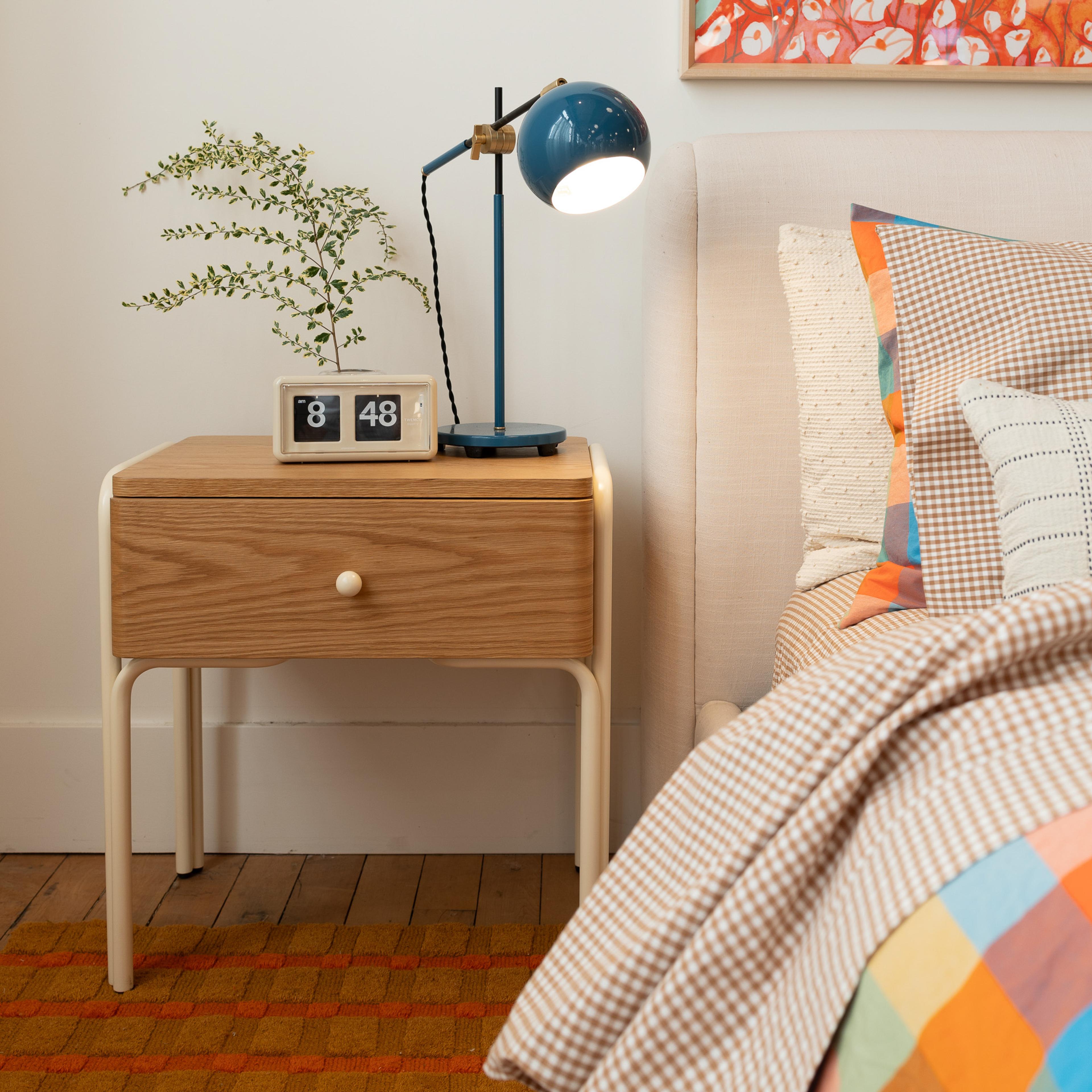 bedroom nightstand with blue lamp 